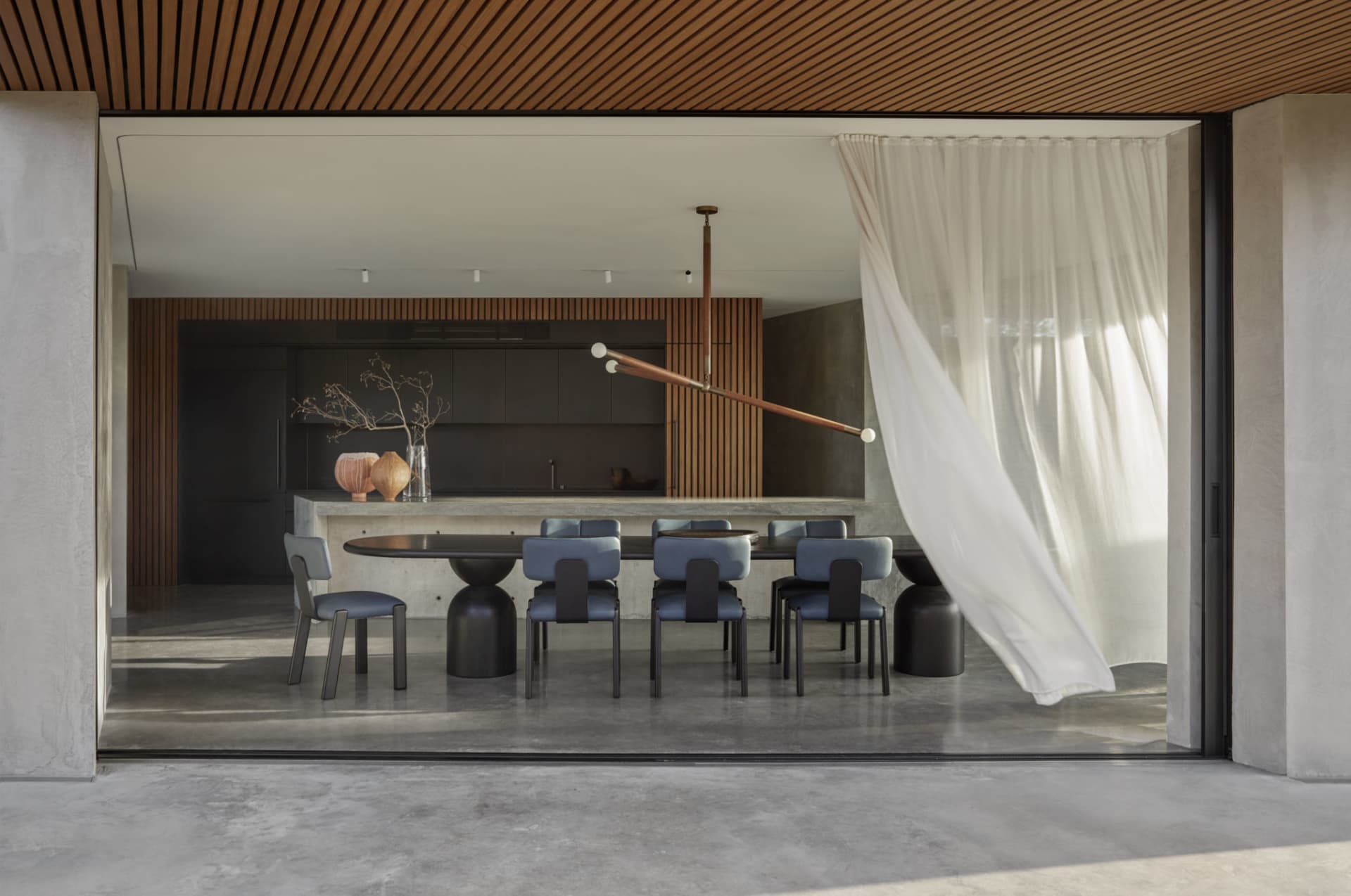 Modern dining room featuring concrete flooring and minimalist design.