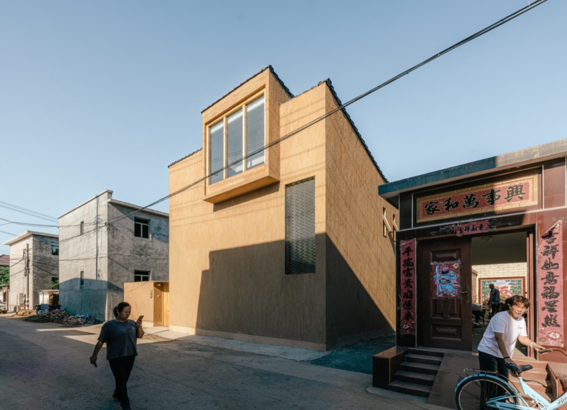 A modern storefront with a sandstone exterior.