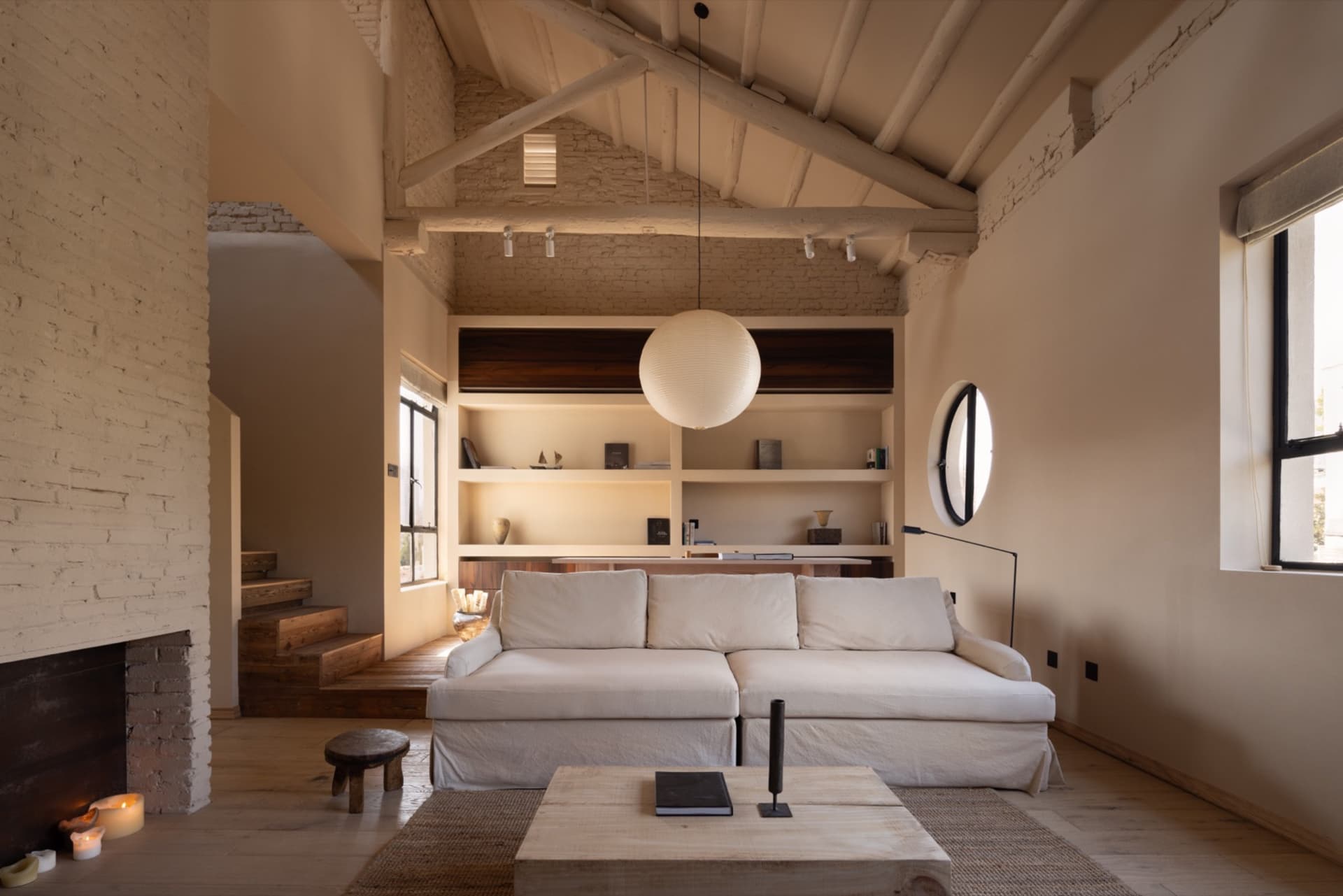 A minimalist living room featuring wooden and concrete elements.