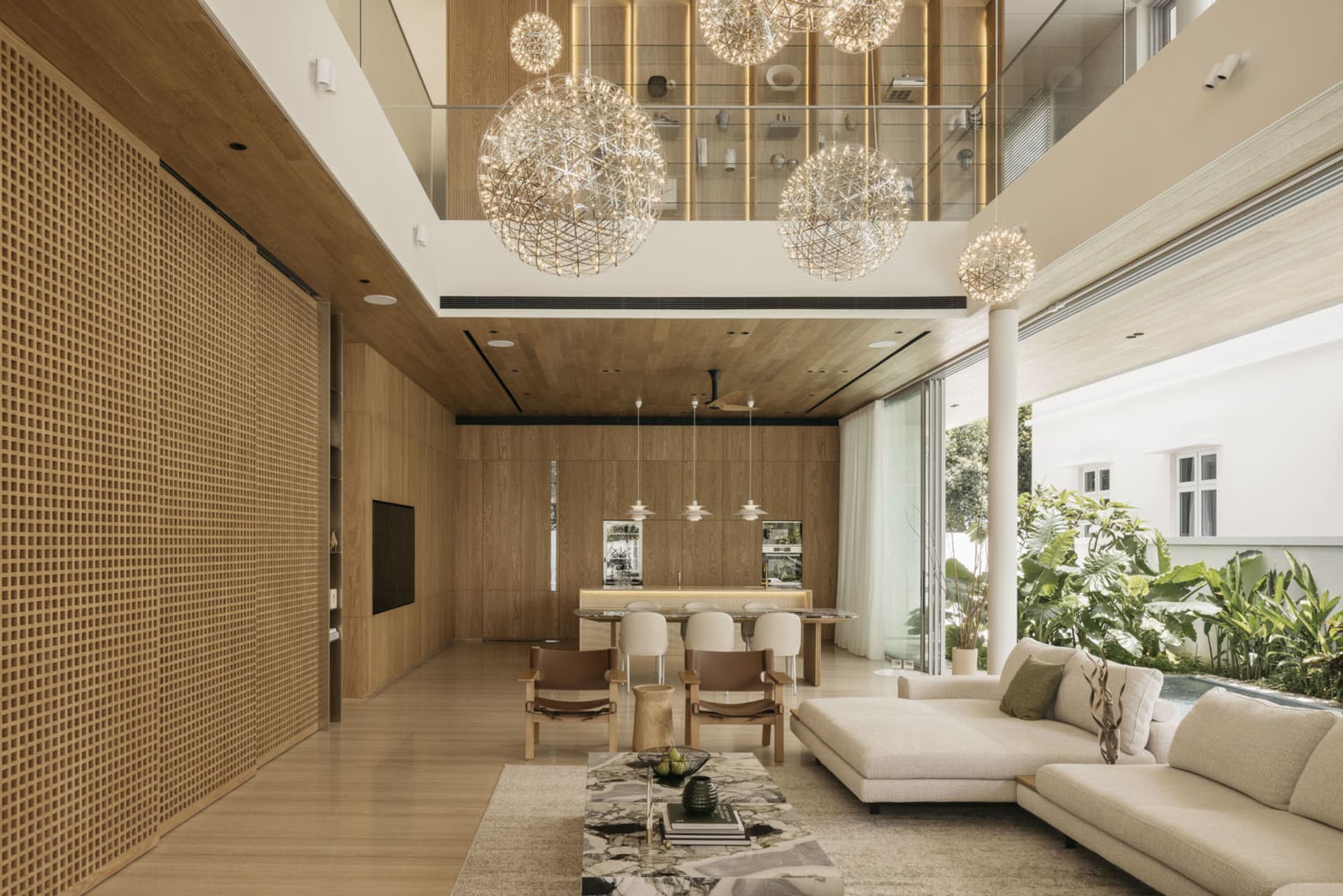 A spacious modern living room with wooden elements, featuring minimalist furniture and large windows.