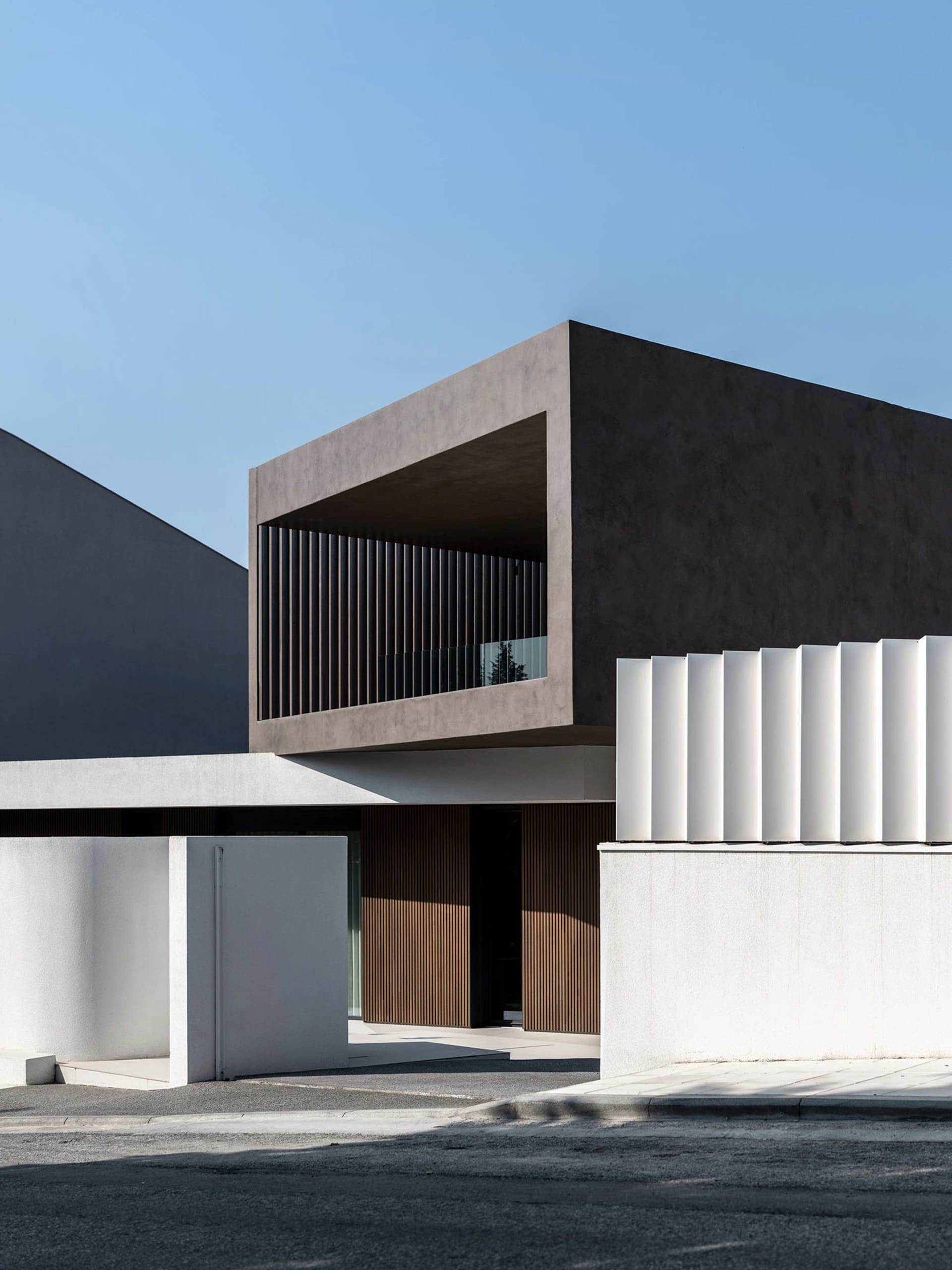 A minimalist house with concrete and wooden exterior.