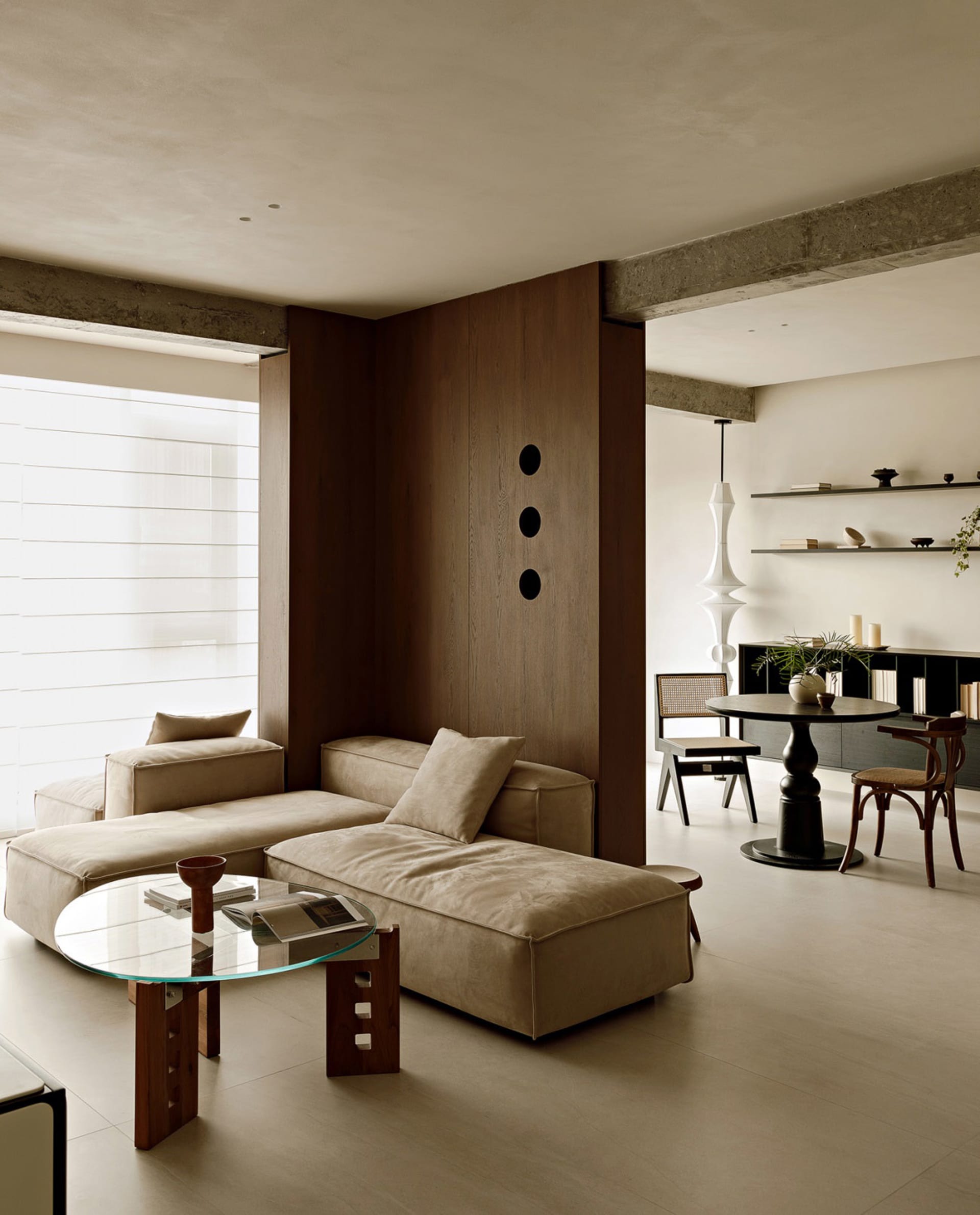 A modern neutral-toned living room with a minimalist design.