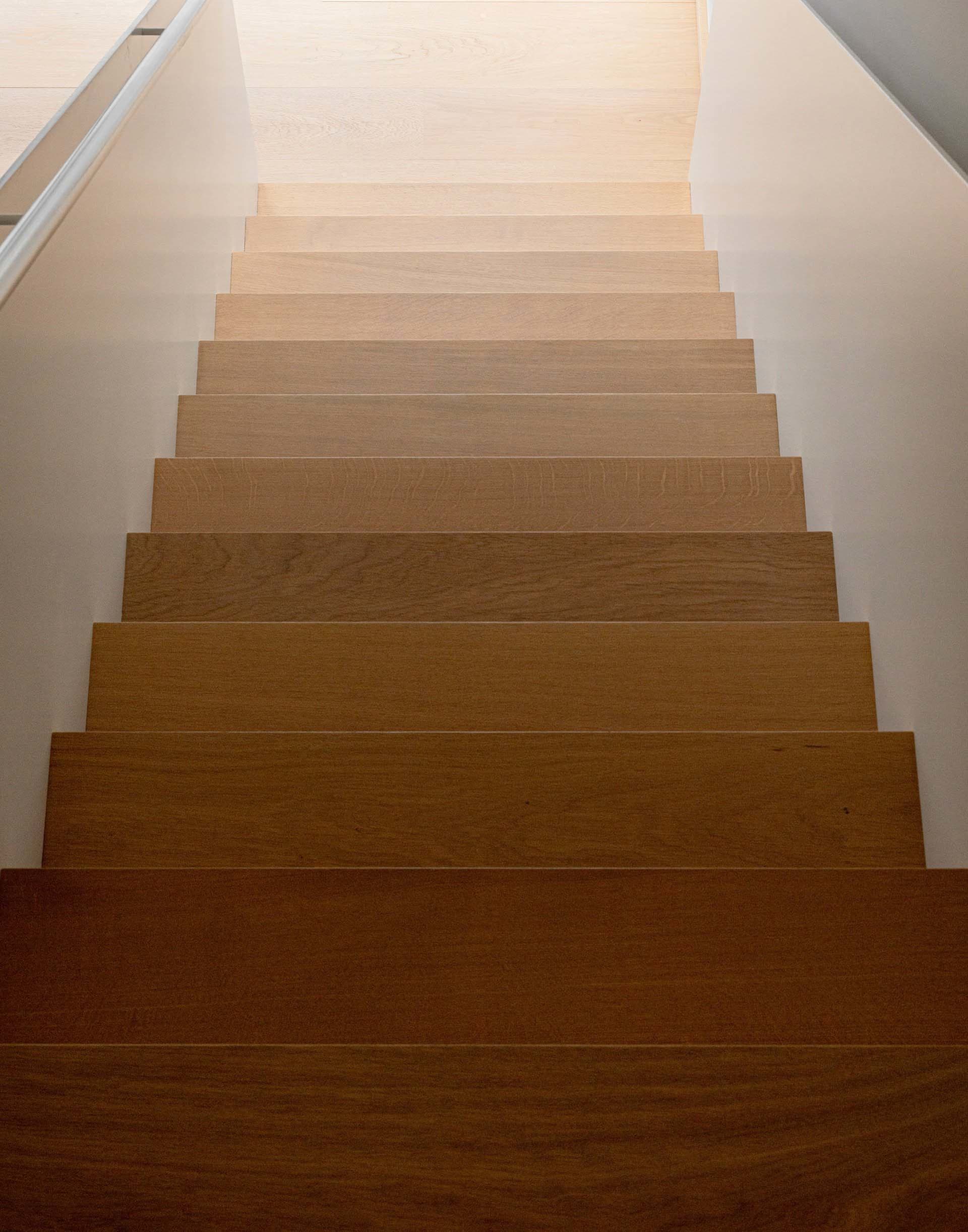 Modern minimalist wooden staircase with gradient shading
