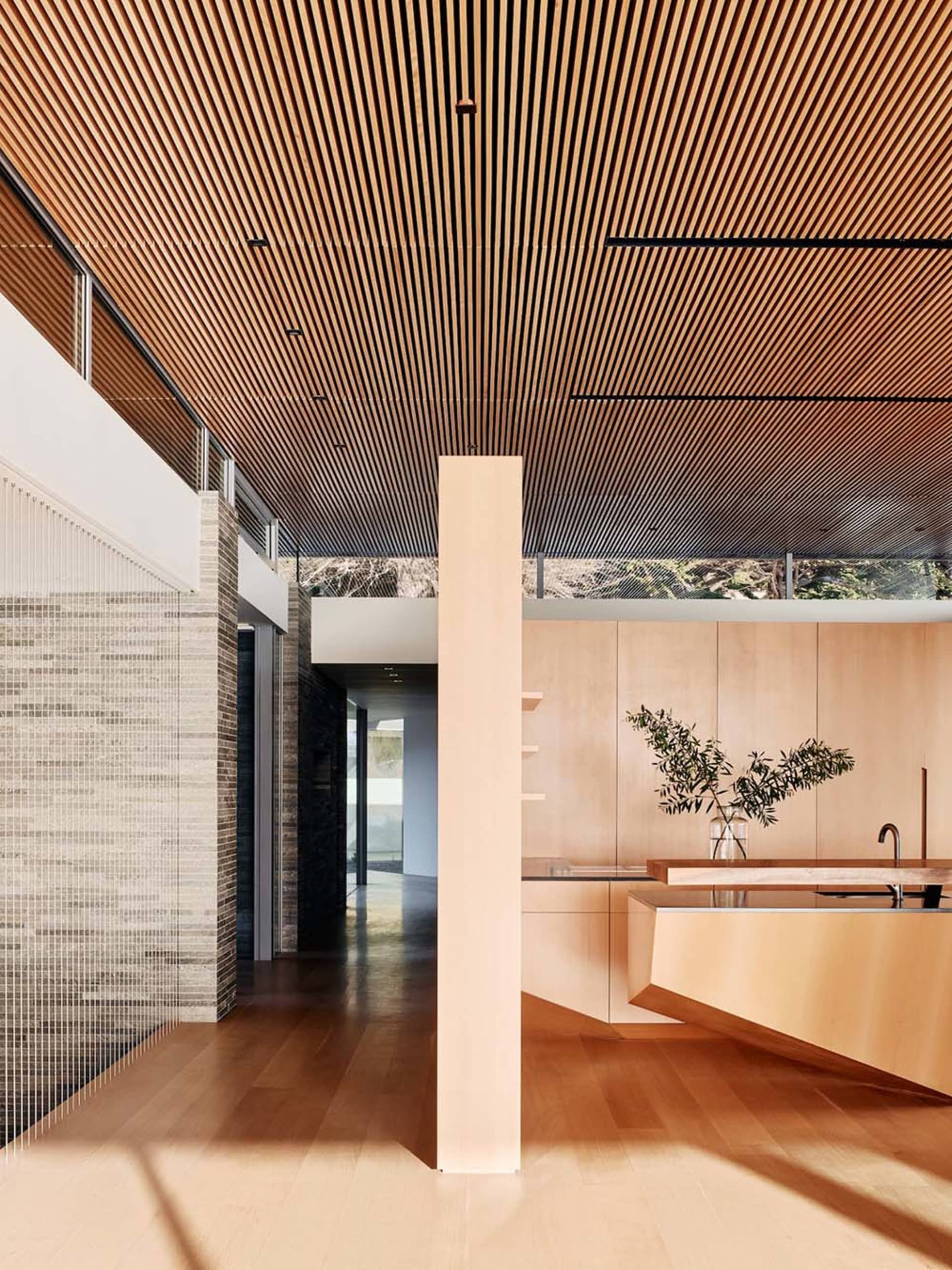 Modern minimalist kitchen with wooden cabinets and open floor plan
