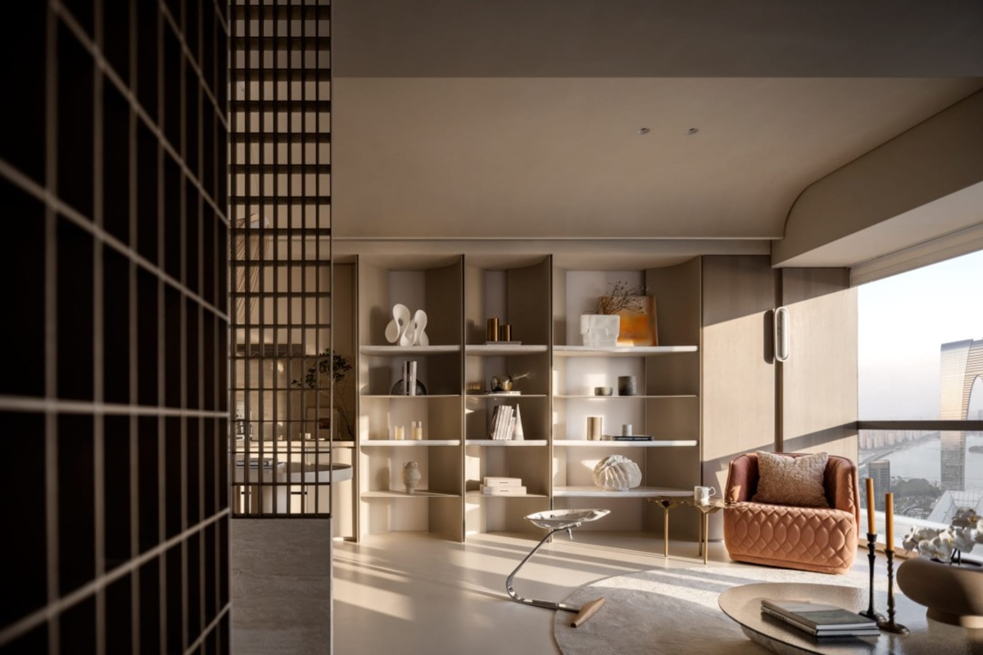 Modern indoor space featuring neutral tones, glass, and metal decor.