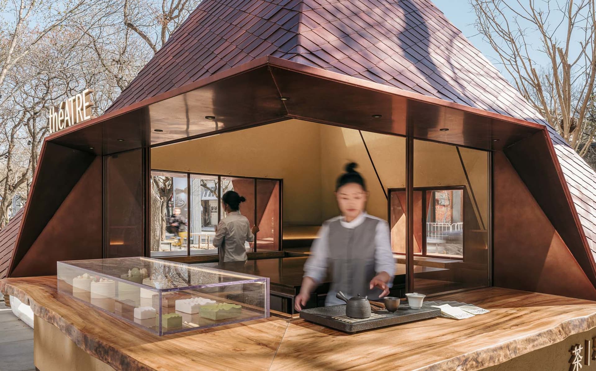A modern food court concept with a wooden counter displaying pastries.