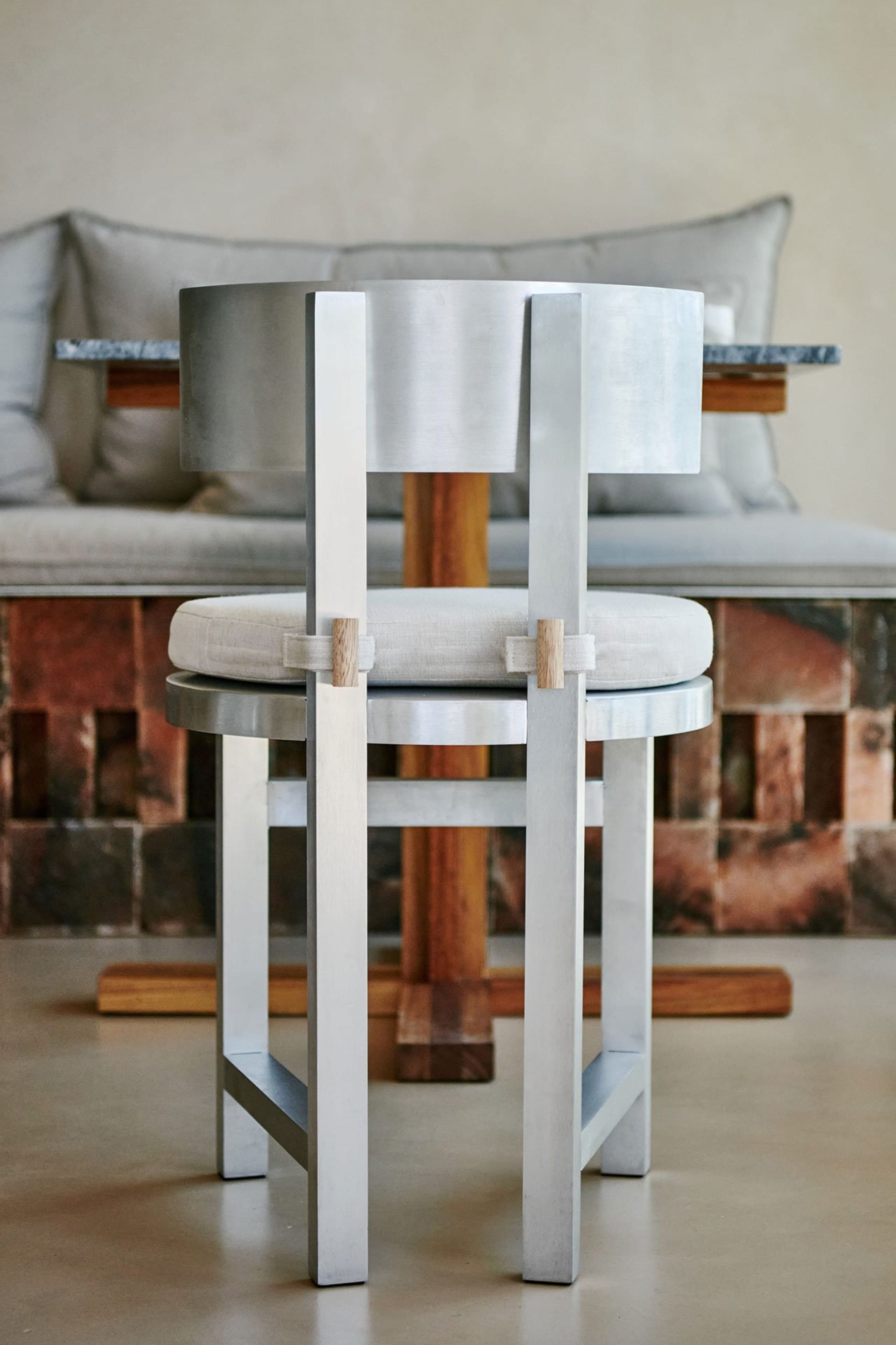 Modern white cushioned chair with metal frame and wooden accents