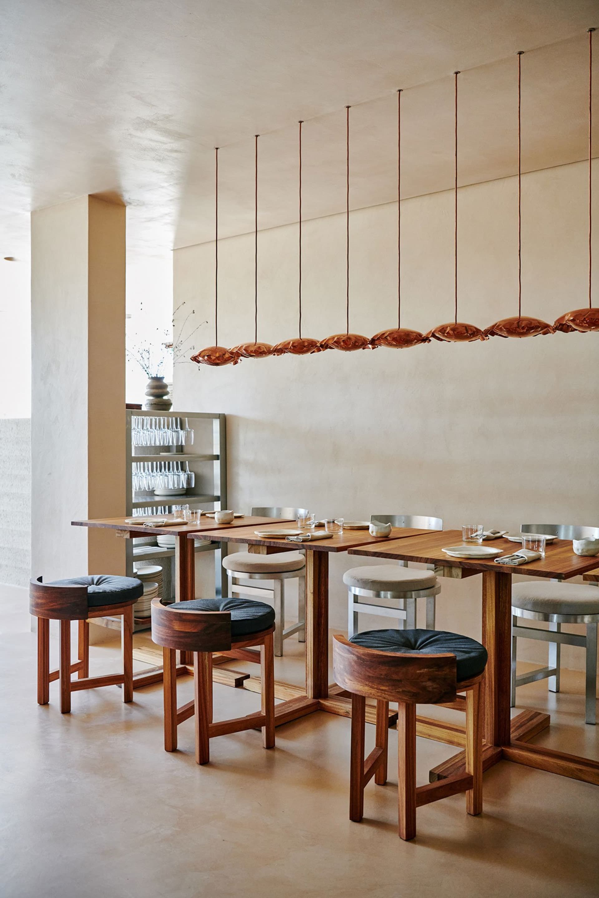 A modern restaurant interior with wooden furniture and a warm, welcoming atmosphere.