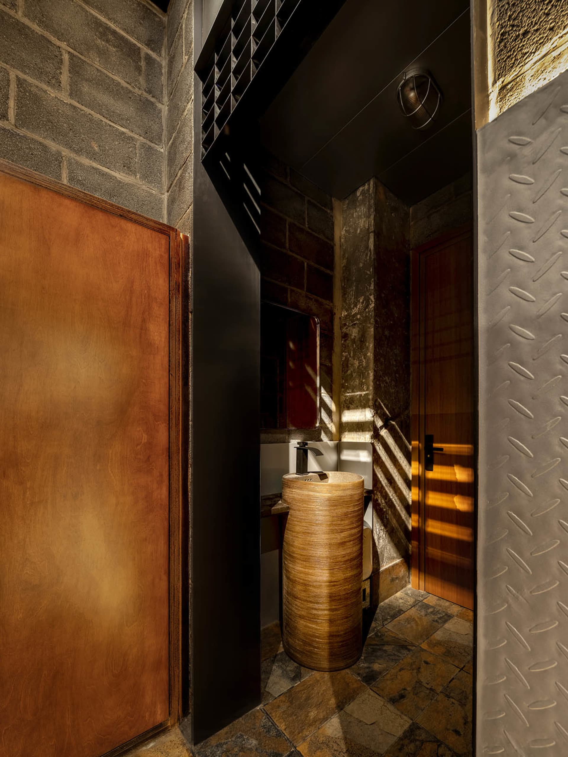 Modern bathroom with wooden vanity and concrete walls