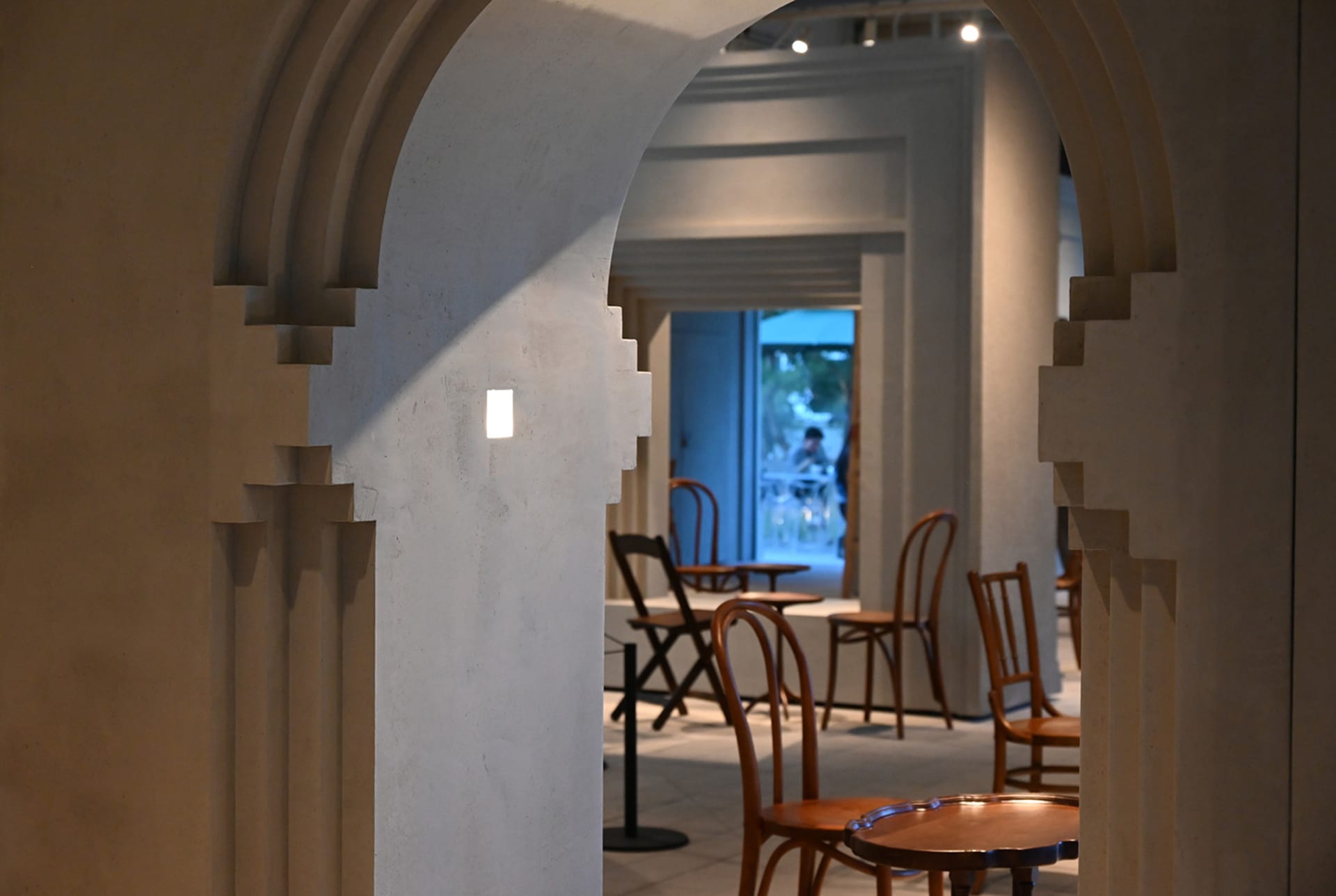 Modern coffee shop interior with wood and concrete arches