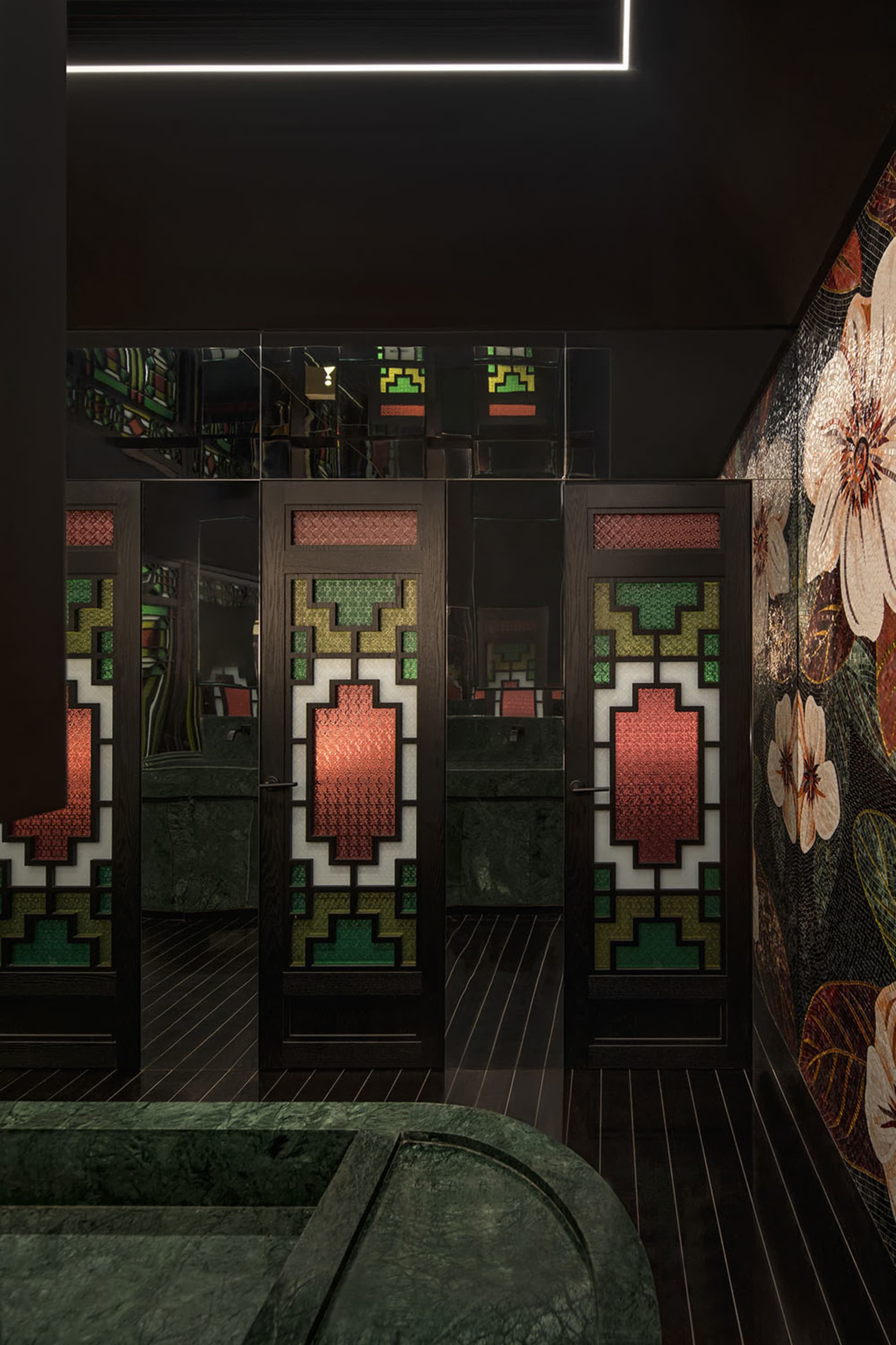 The front entrance of a modern restaurant featuring intricate stained-glass doors with geometric patterns.