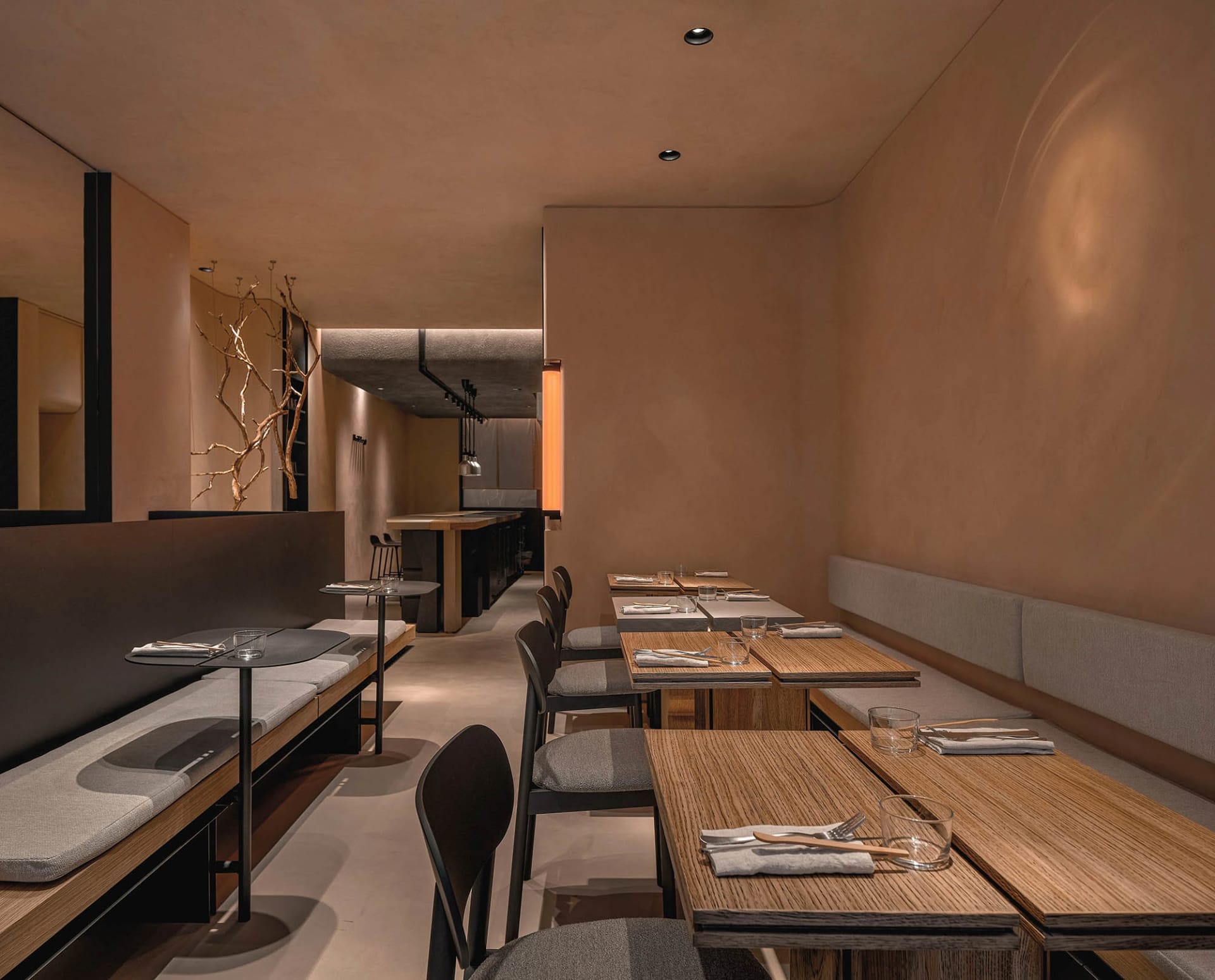 Modern minimalist restaurant interior with wooden benches and fabric seating