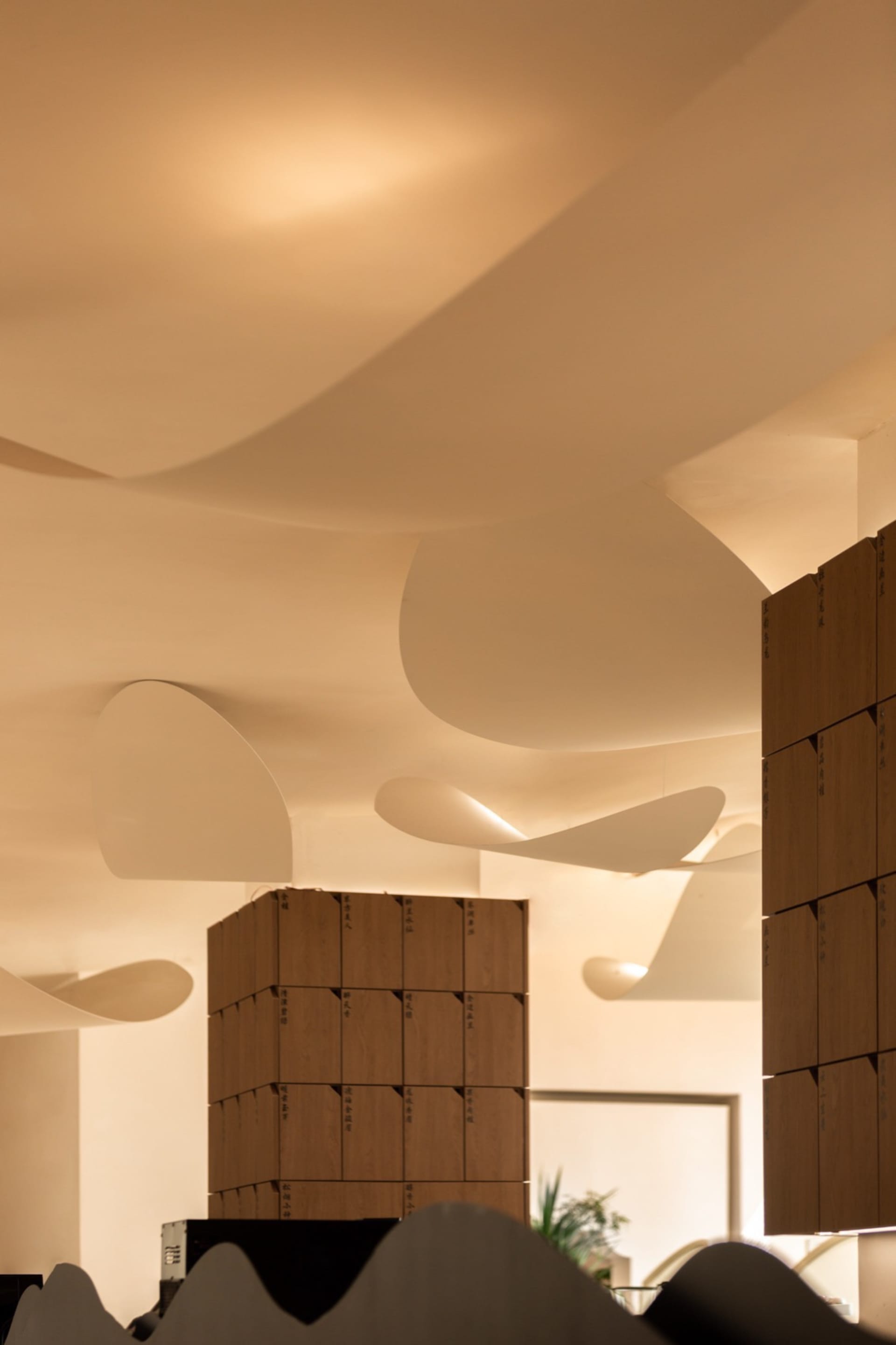 A modern office space featuring curved concrete walls.