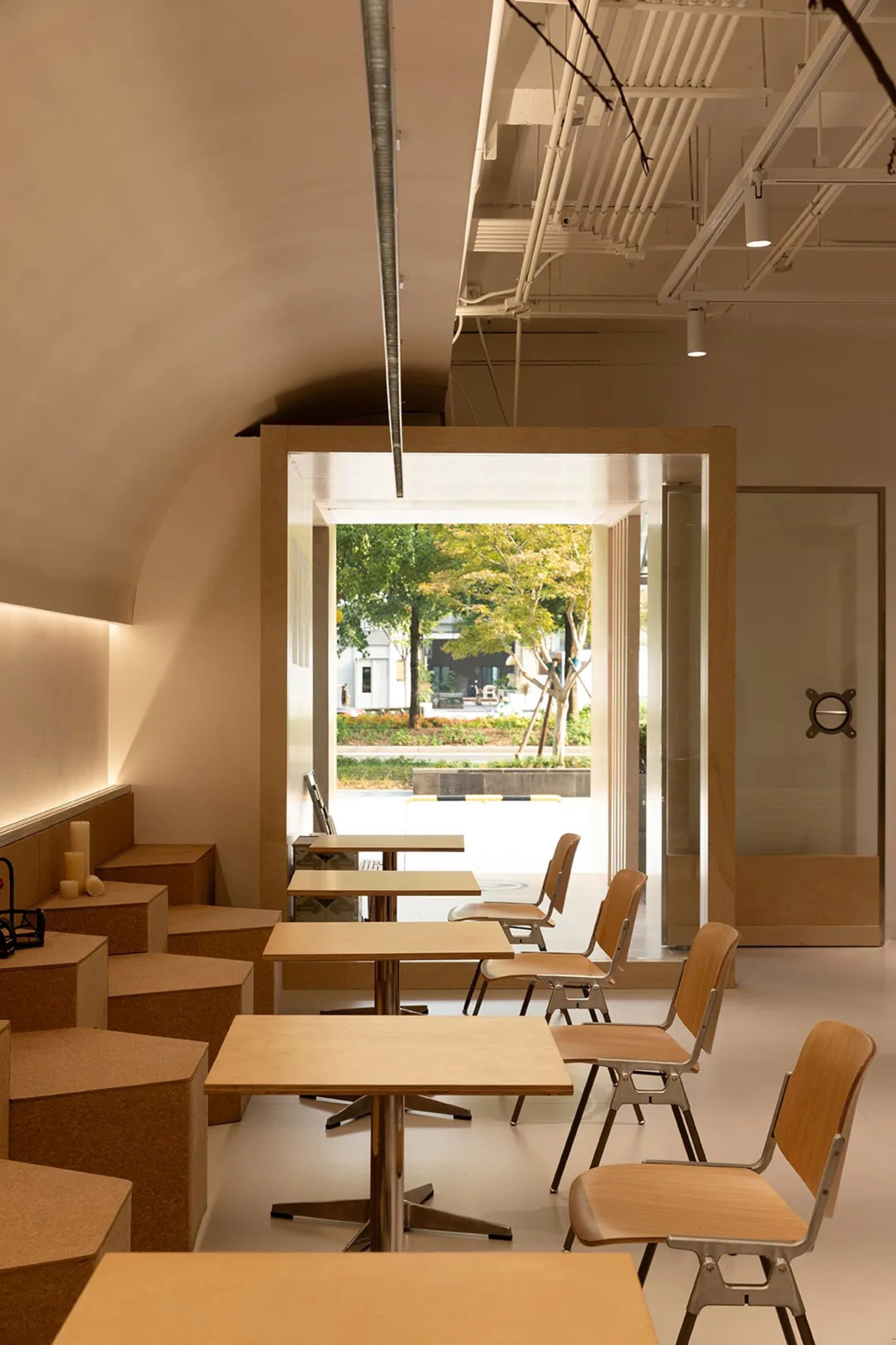 Minimalist cafe interior with wooden tables and chairs