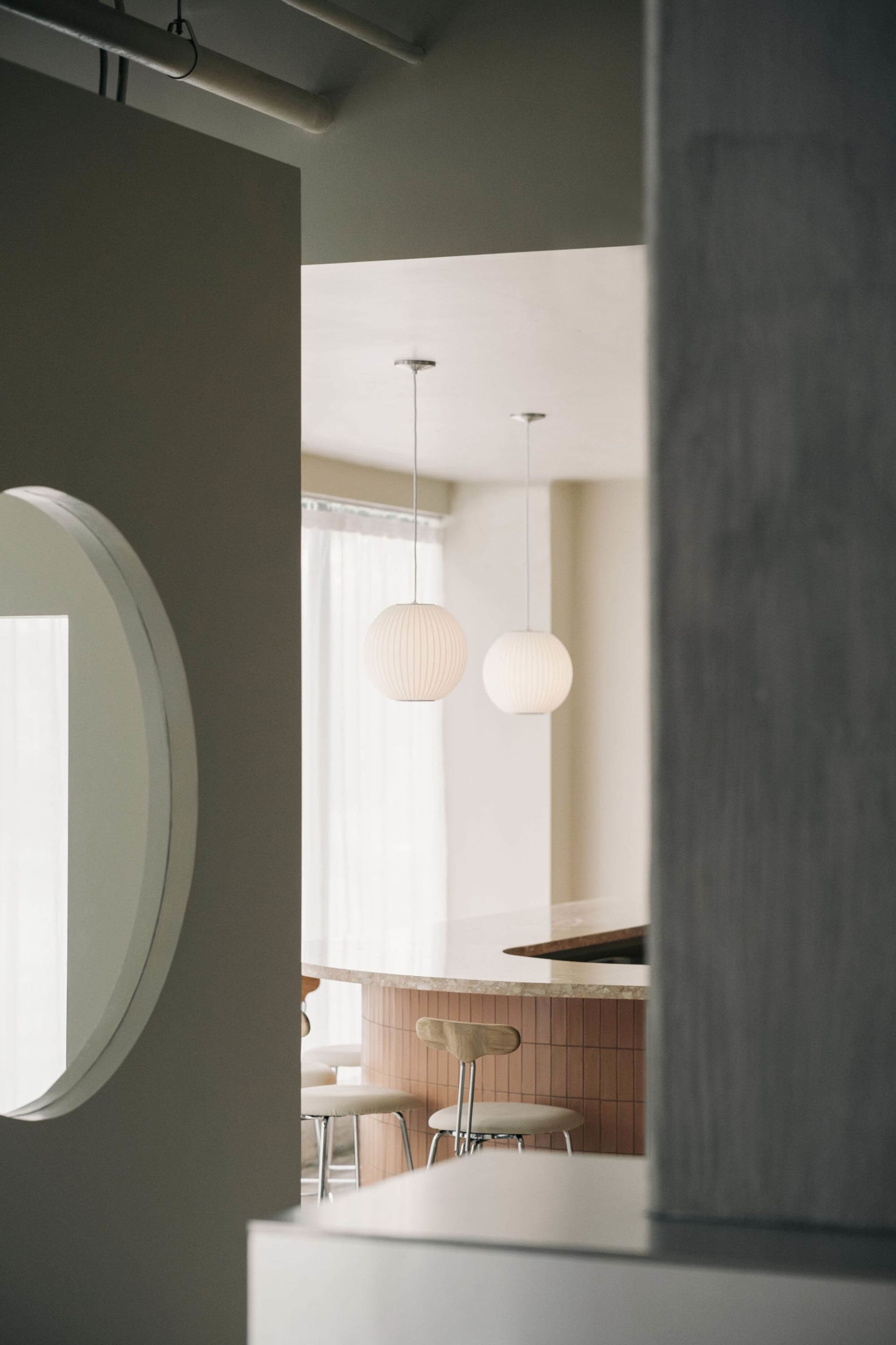 Modern, white-concrete restaurant interior with minimalist design.