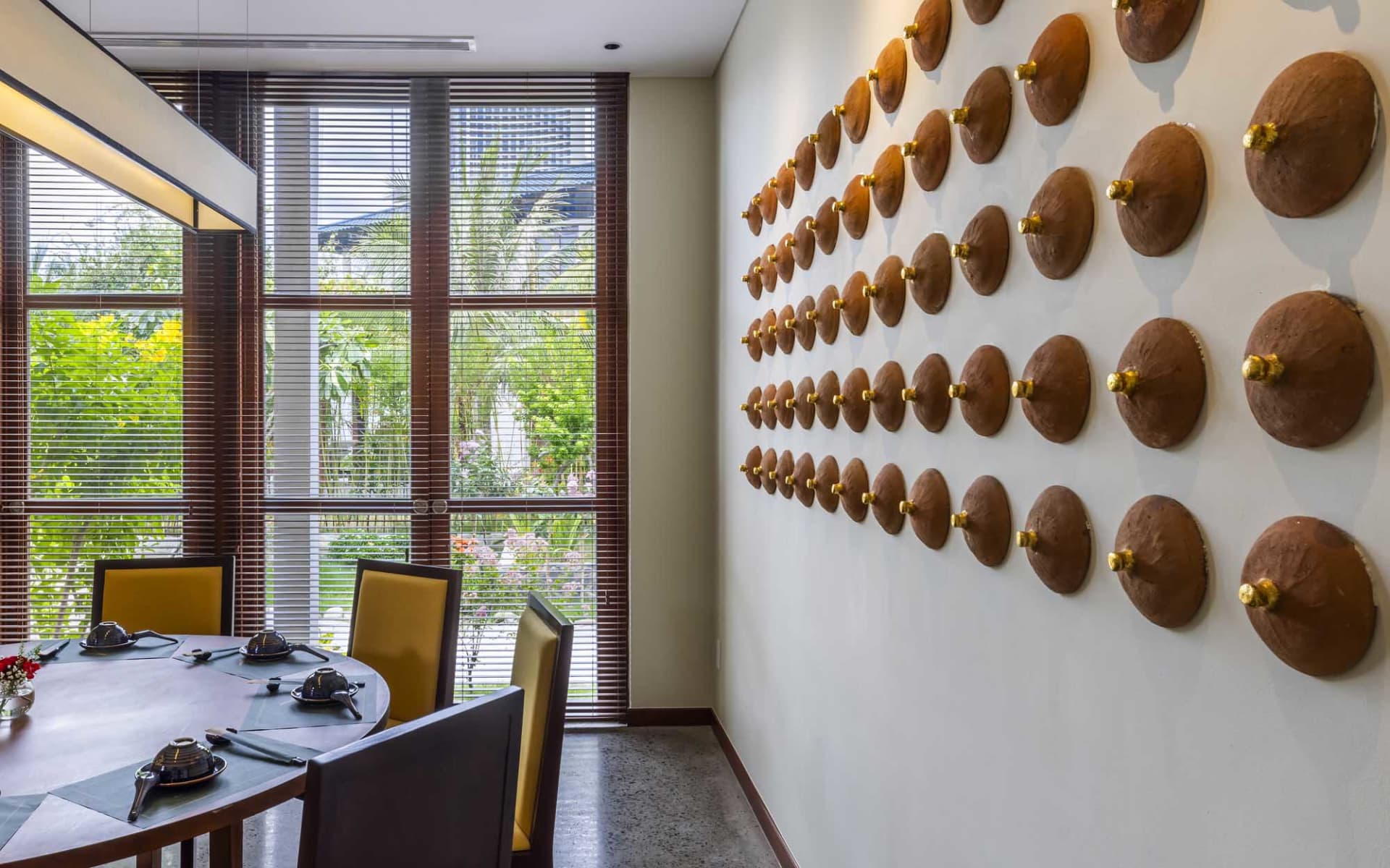 Modern dining room featuring wooden furniture and decorative wall art.