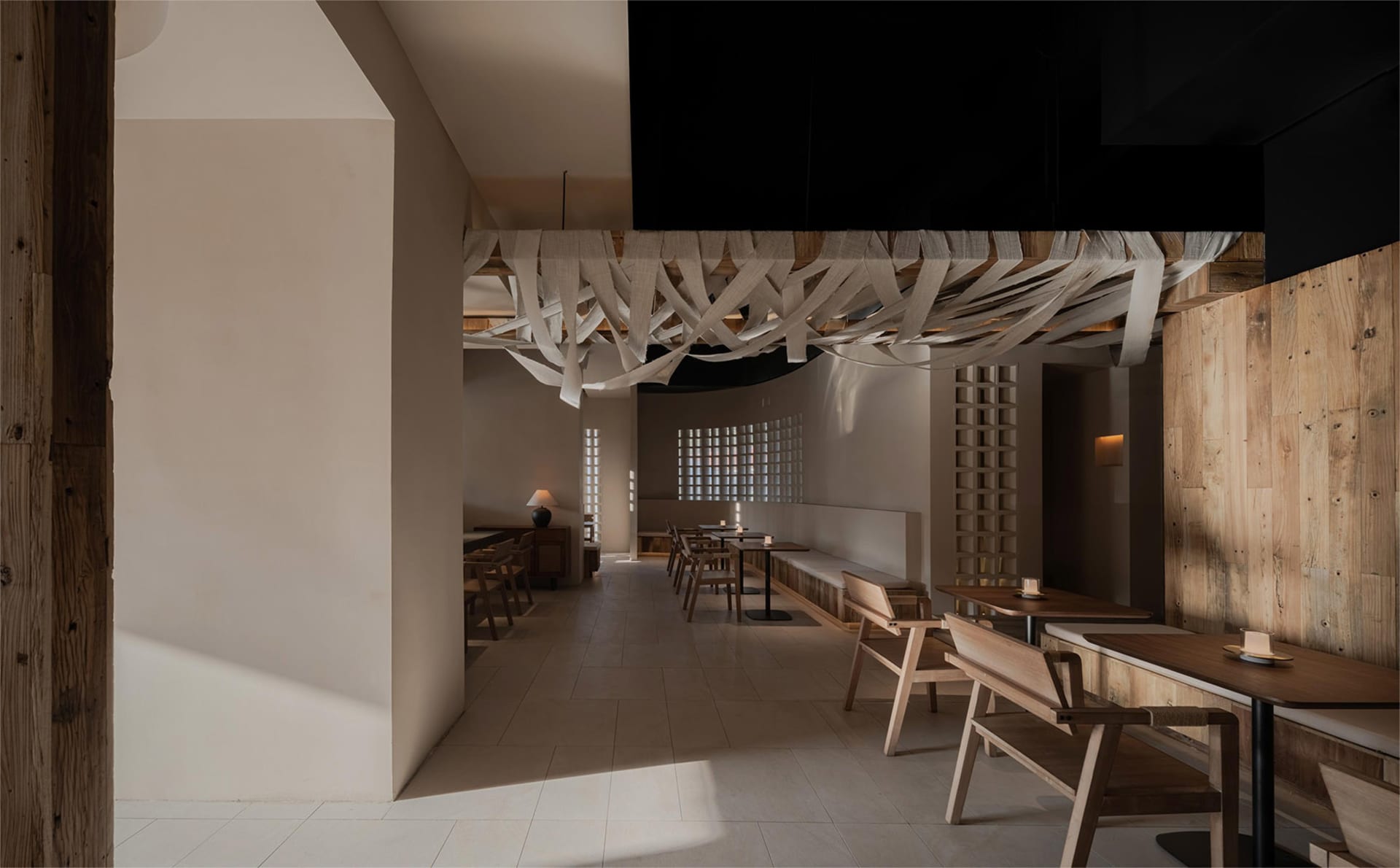 Interior design of a minimalist restaurant featuring wooden materials.