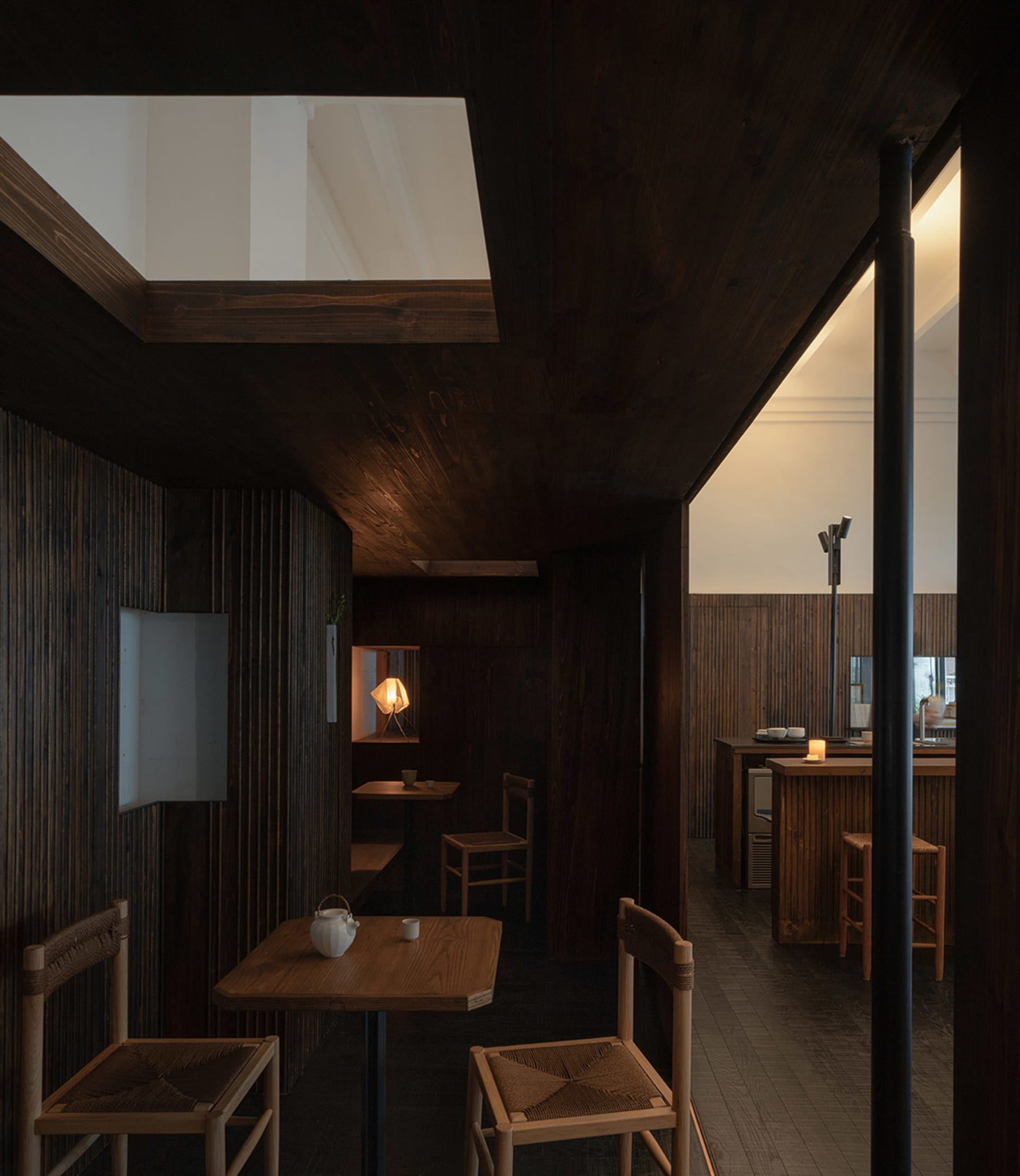 Industrial-style restaurant interior with wooden structures and tables