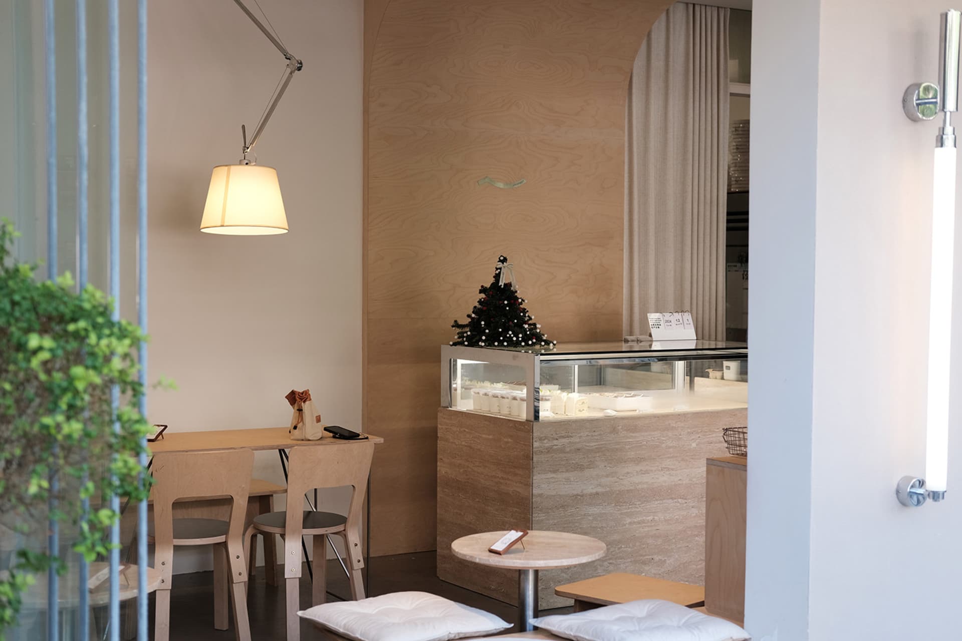 Interior design of a modern cafe with wooden chairs and marble tables.