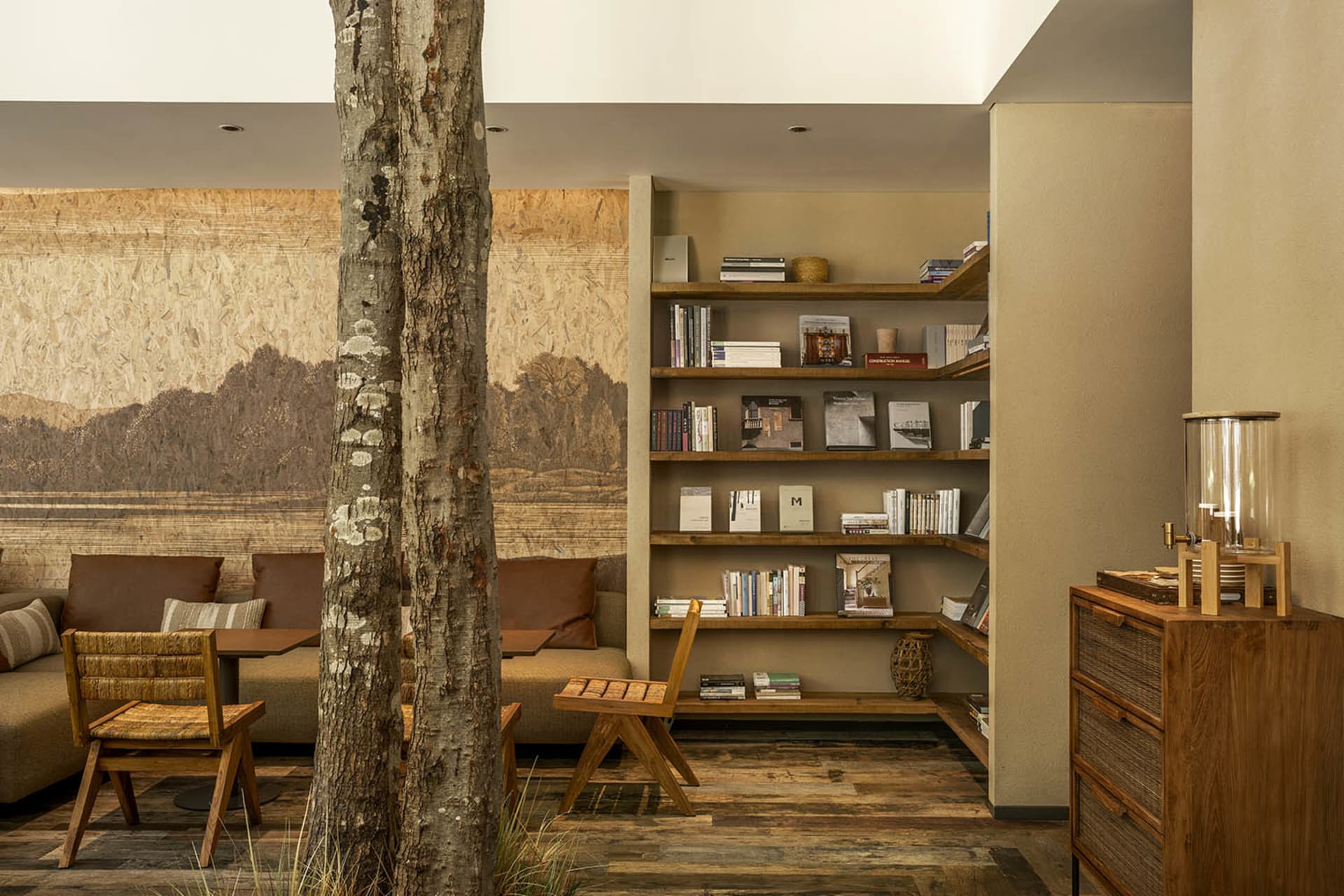 A modern living room with wooden furniture and a large bookshelf.