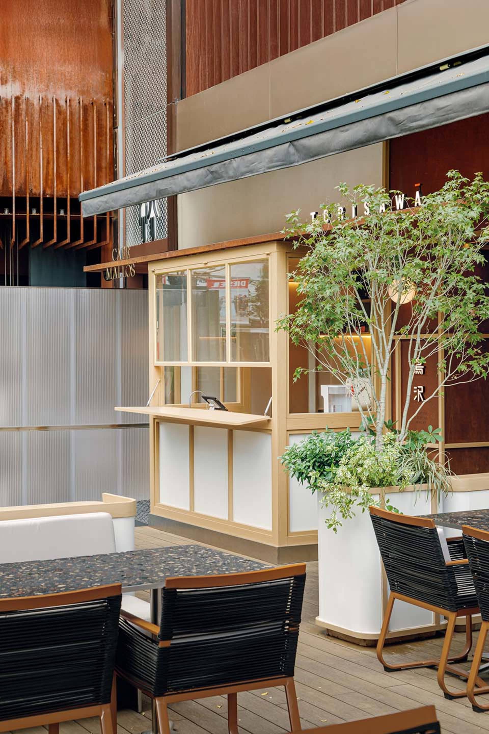 Outdoor seating and modern glass facade of a cafe