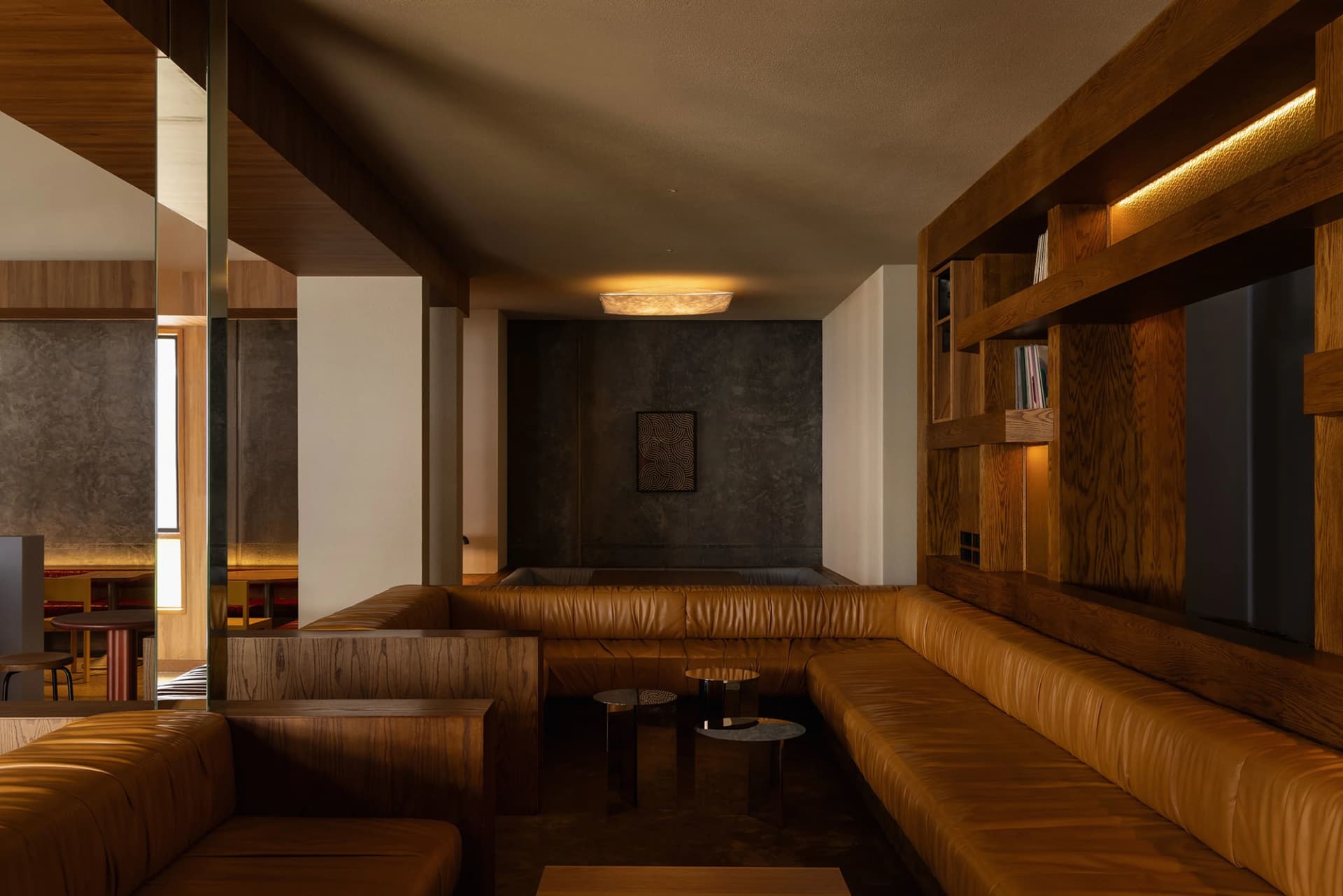 Modern loft space with leather seating and wooden accents.
