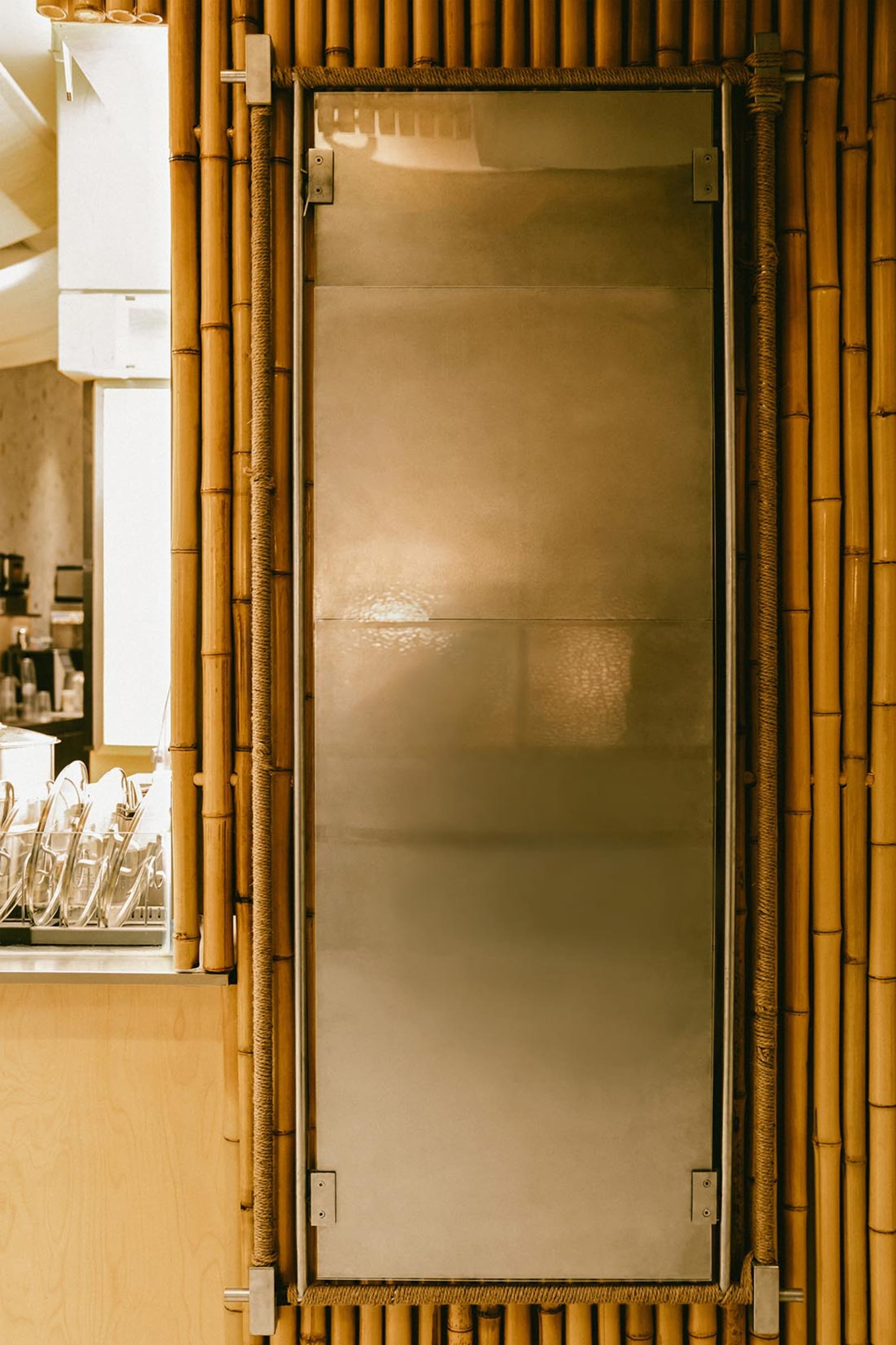 A metal door with a glass panel in a restaurant setting