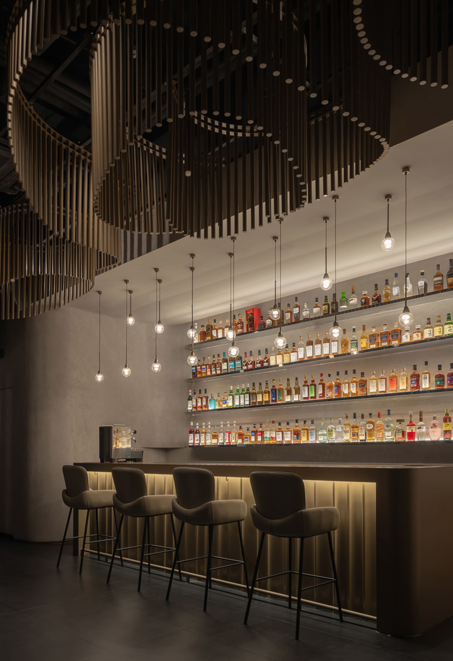 Modern bar featuring metal, wood, and glass elements.