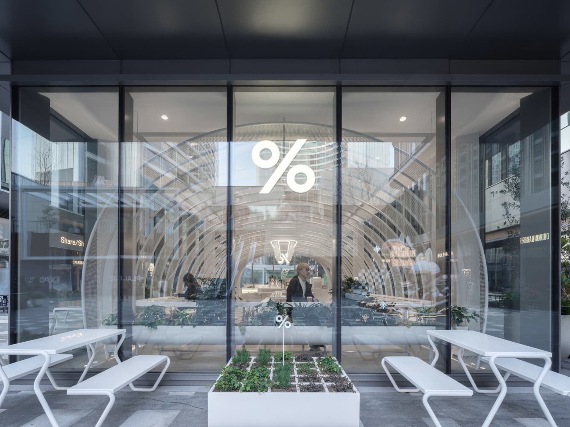 Modern retail entryway featuring glass doors and minimalist interior design.