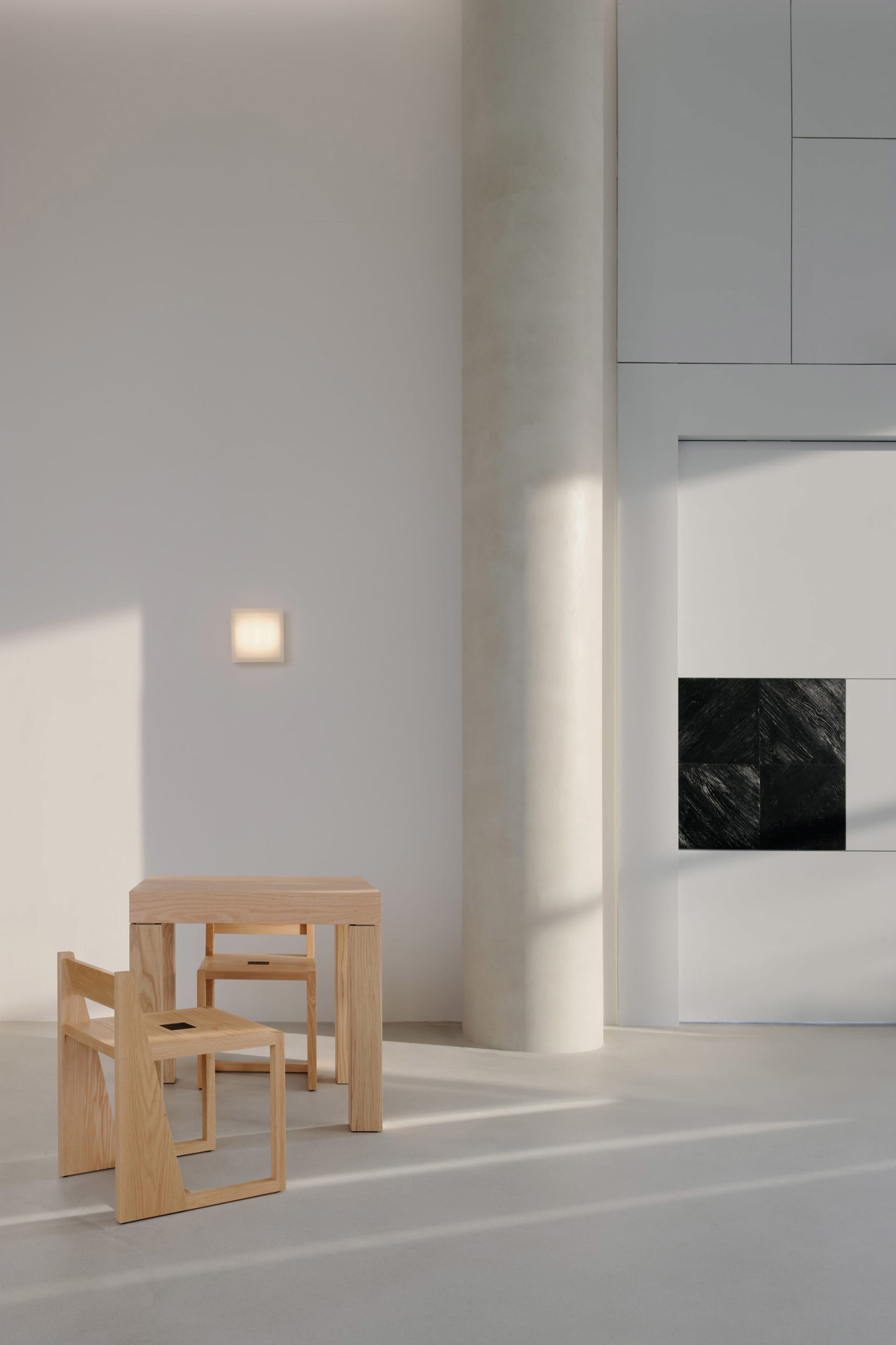 Modern minimalist living room featuring wood furniture and concrete elements.