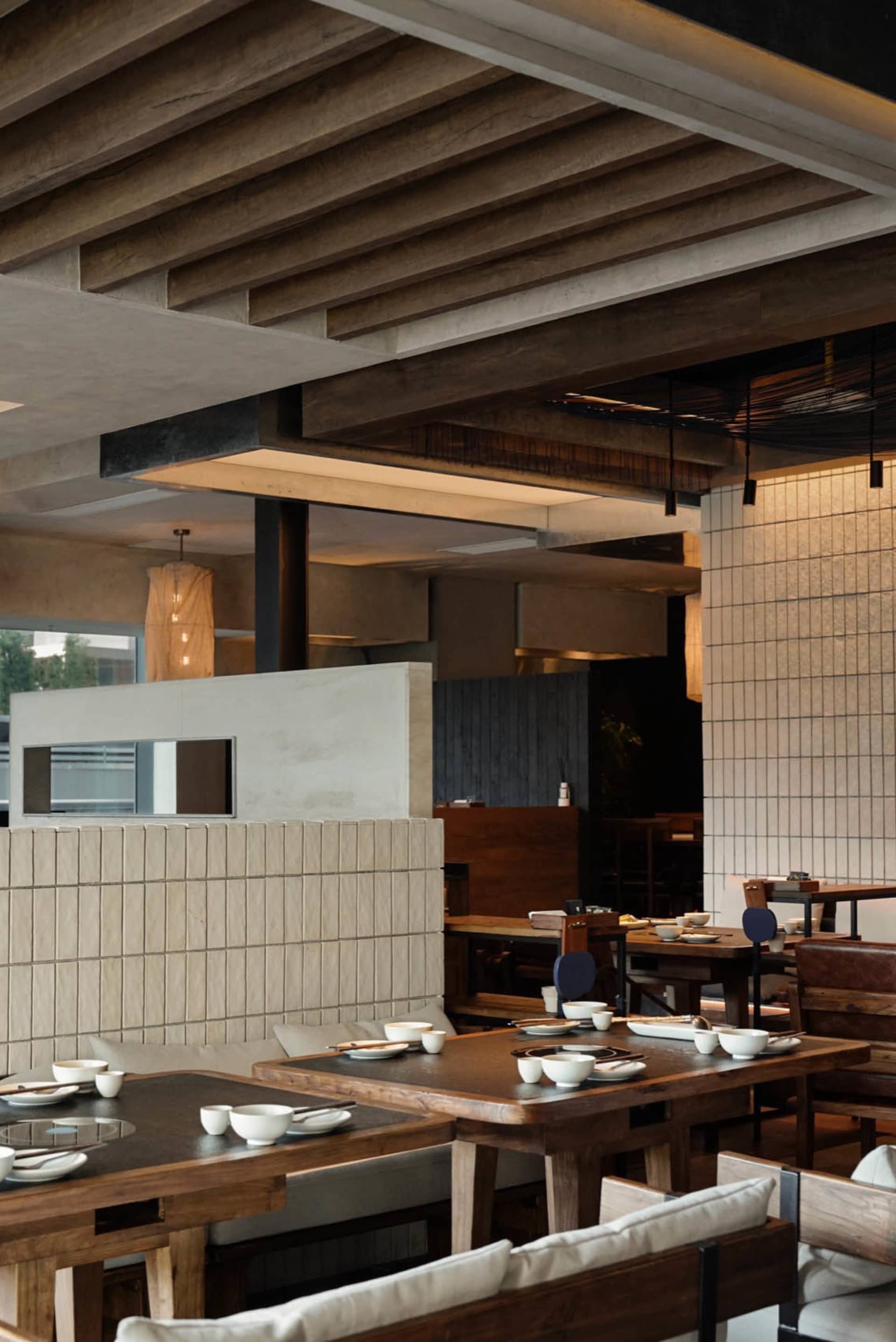 A modern restaurant interior with warm wooden elements, featuring clean lines and minimalist design.