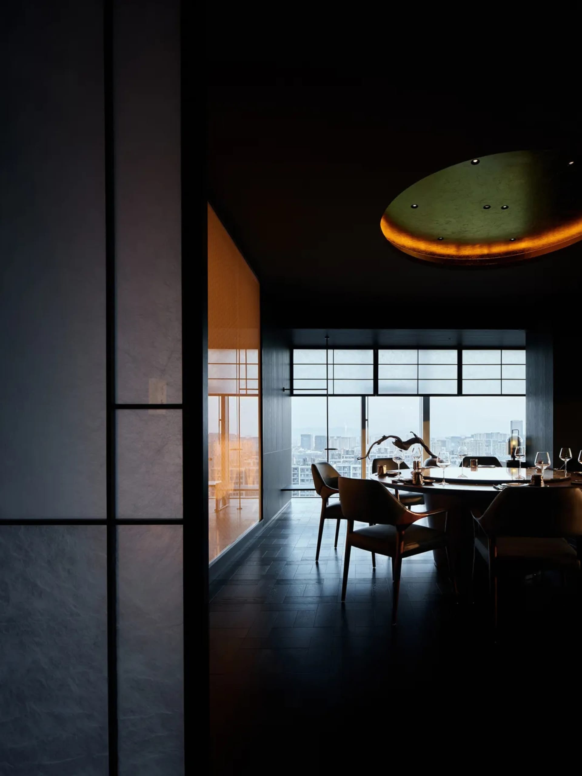 Modern restaurant interior with dark wood flooring and large windows overlooking a cityscape.