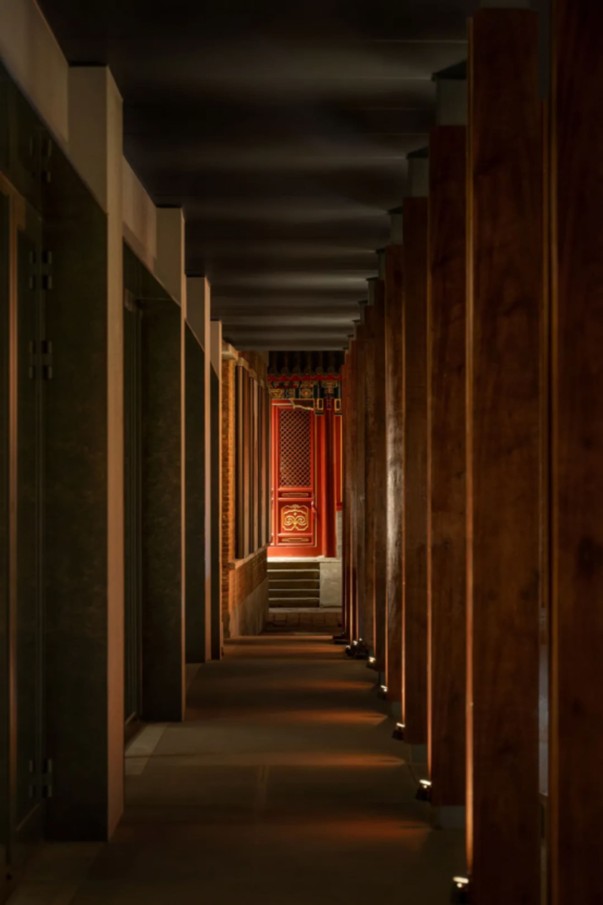 An interior wooden corridor with illuminated flooring and walls