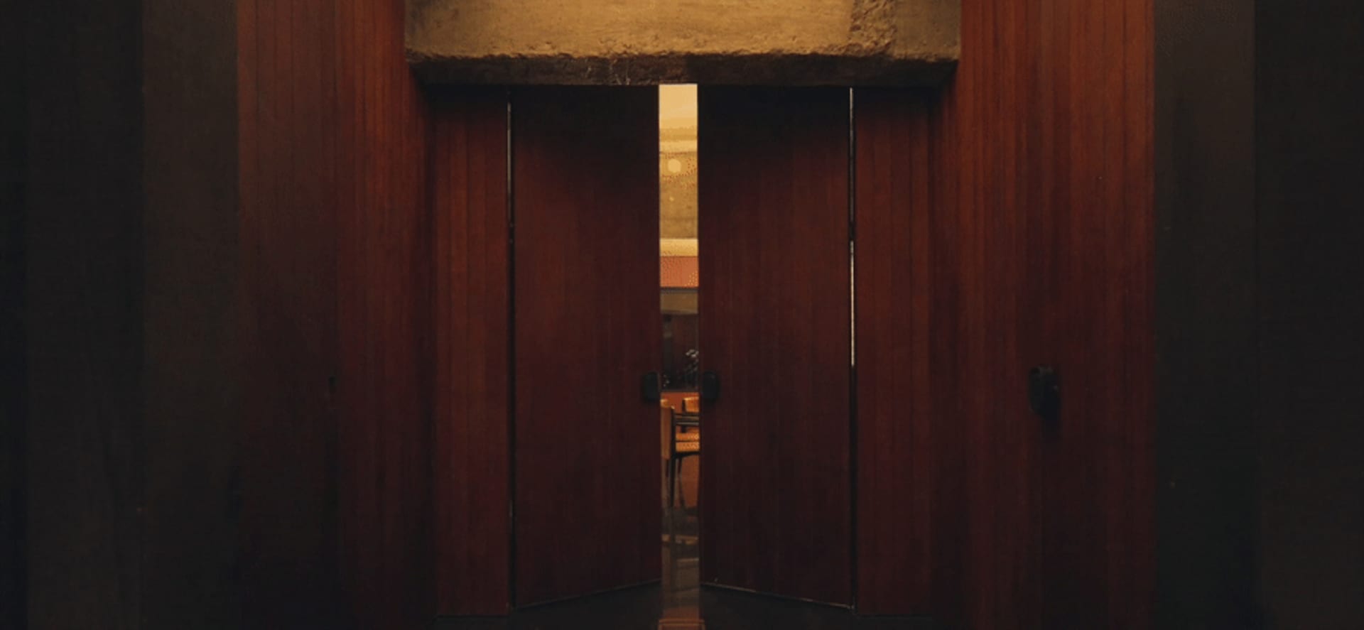 A wooden doorway with a light-colored interior.
