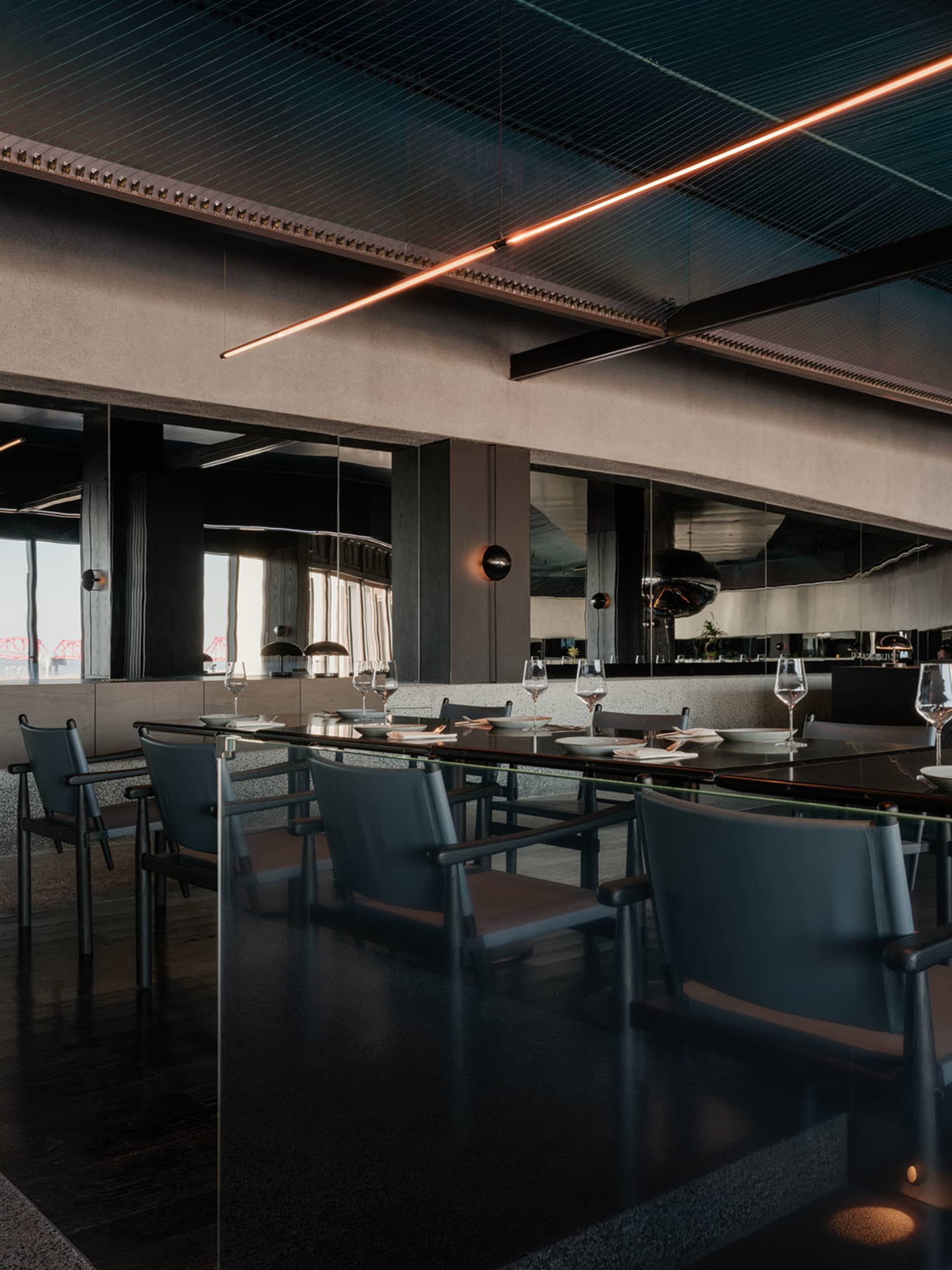 A modern industrial restaurant interior with concrete, glass, and metal materials
