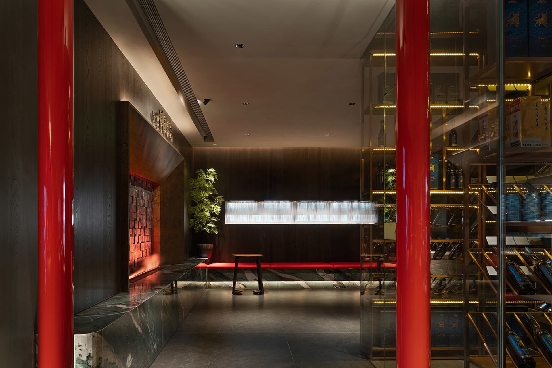 Retail space with red columns, dark wood accents, and glass shelves