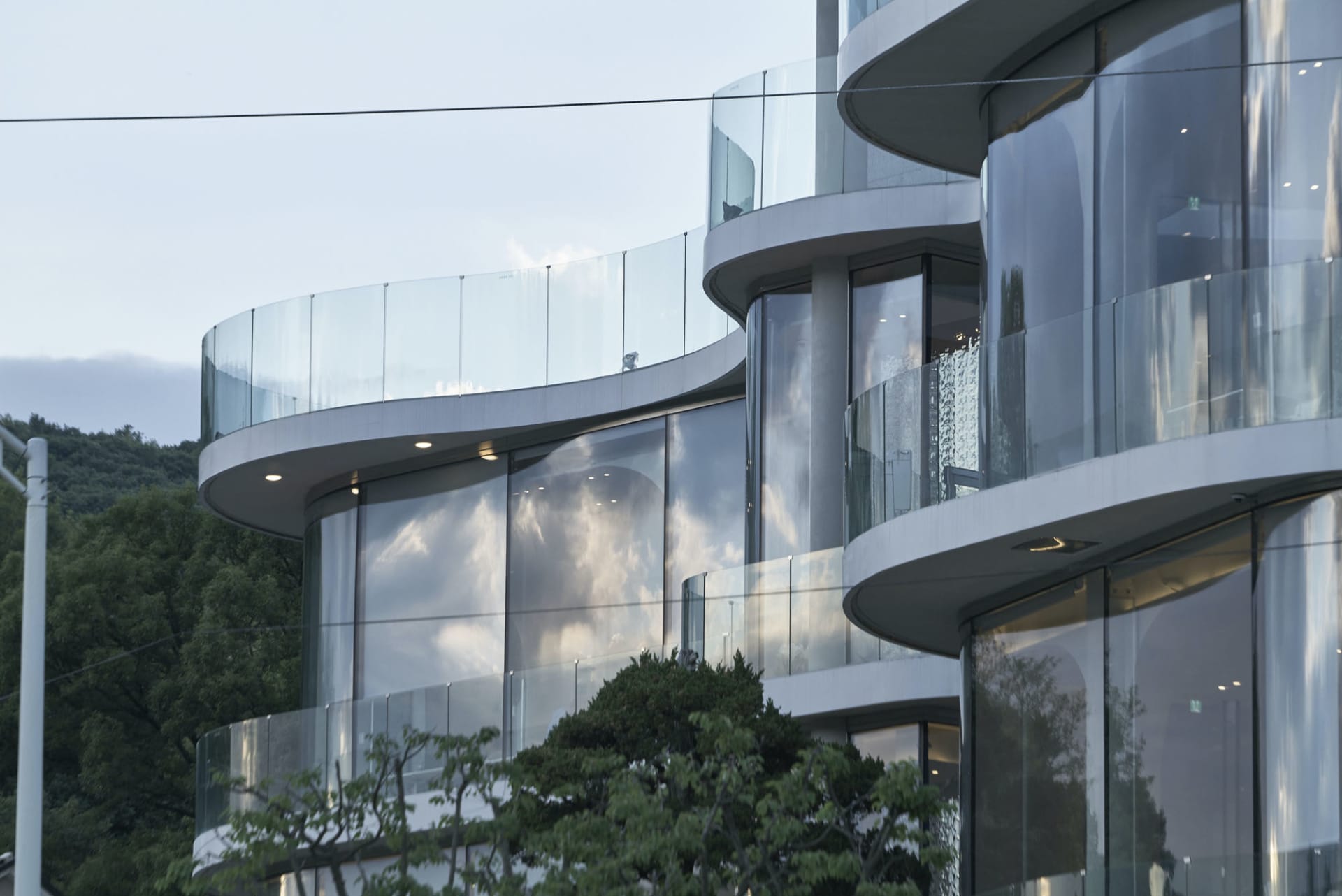 Modern circular glass building exterior with curved balconies