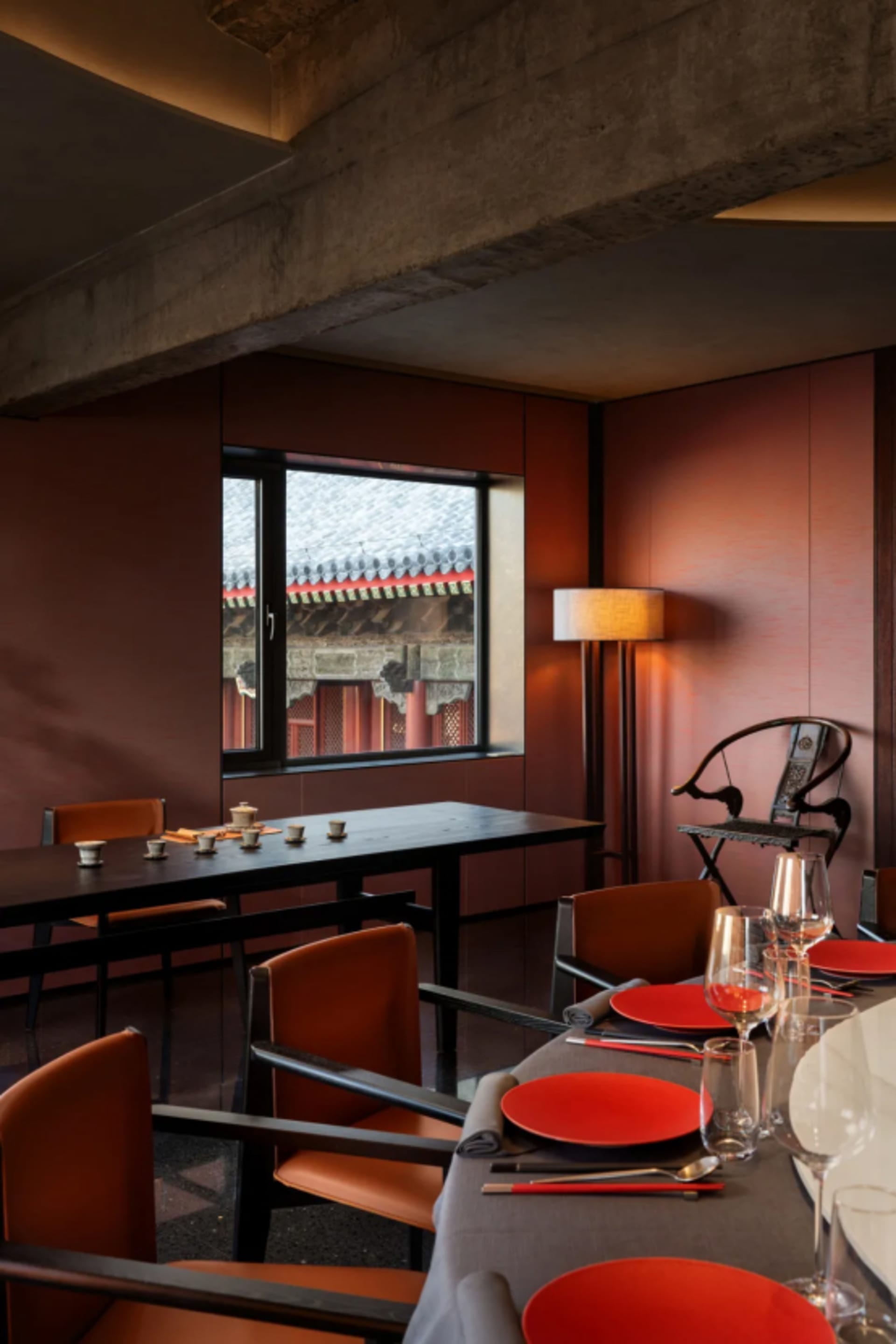 Modern interior with wooden tables and chairs in a restaurant setting.