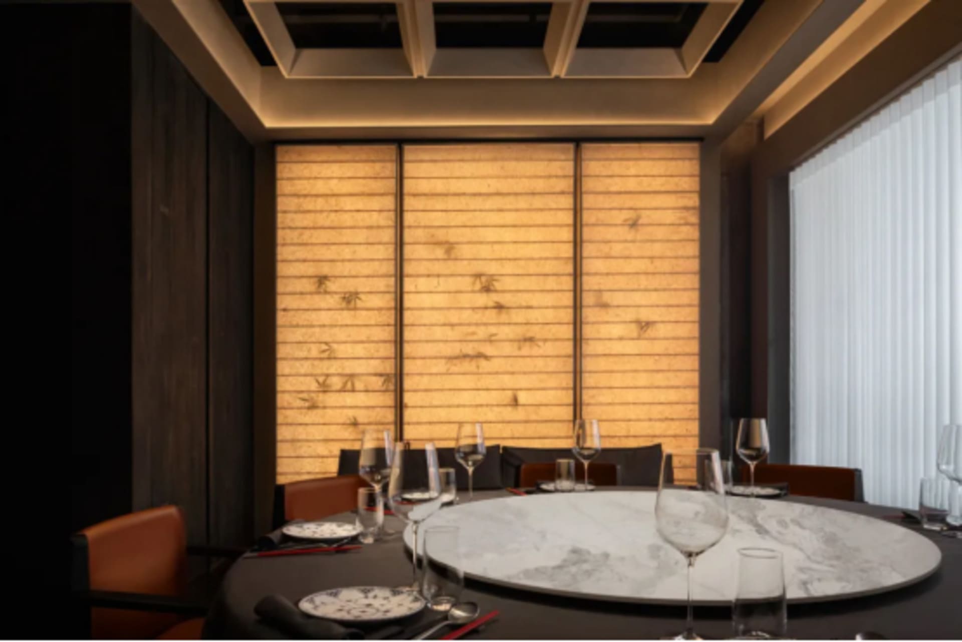 Modern restaurant interior featuring a marble-top dining table.