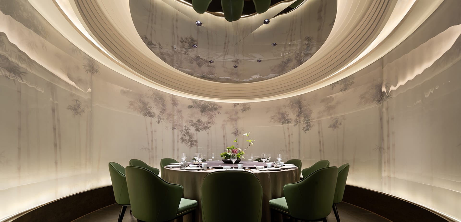 Elegant, modern restaurant interior with paper wall covering, carpet, and green chairs.