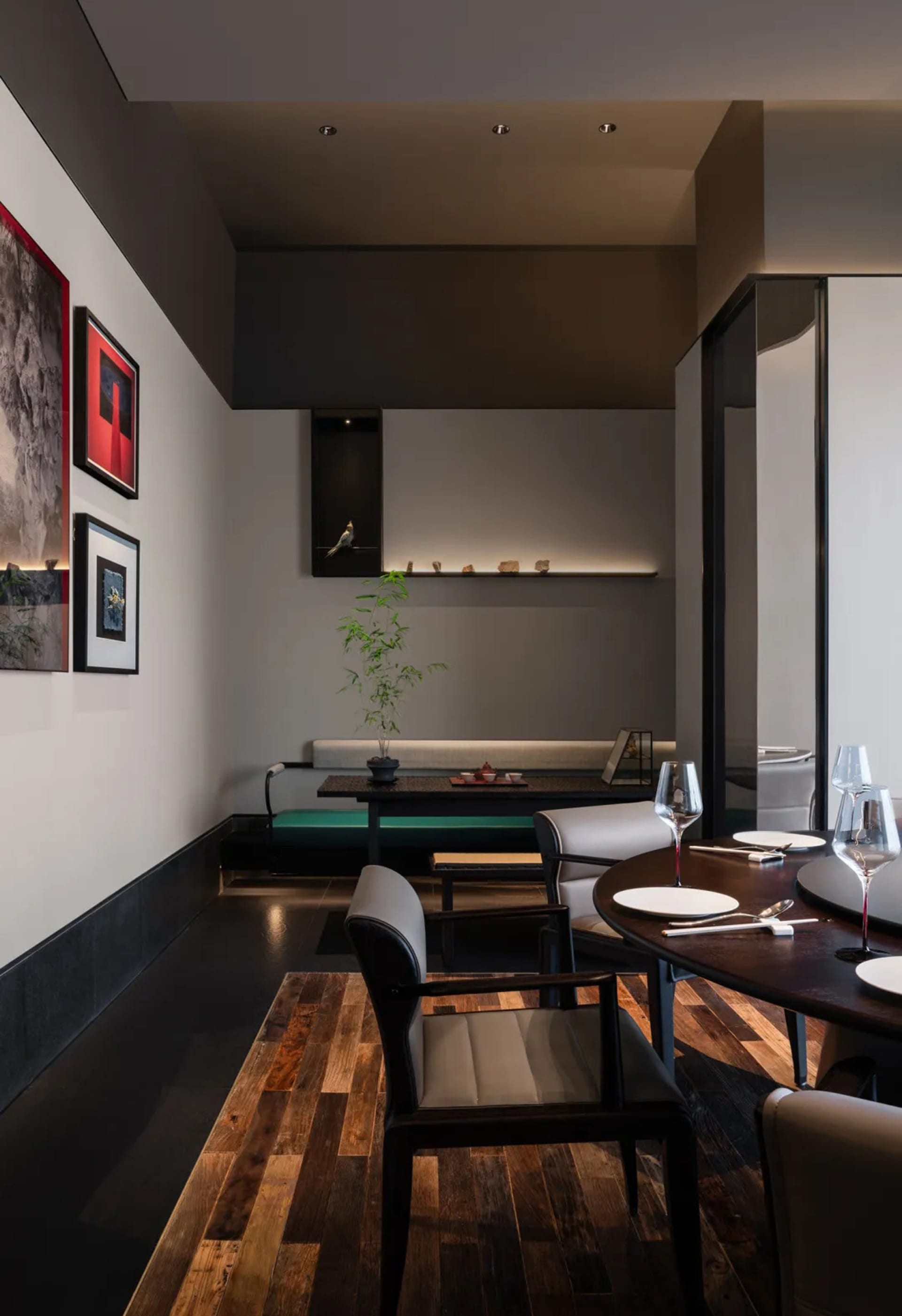 Modern restaurant interior featuring wooden furniture, glass decor, and marble accents