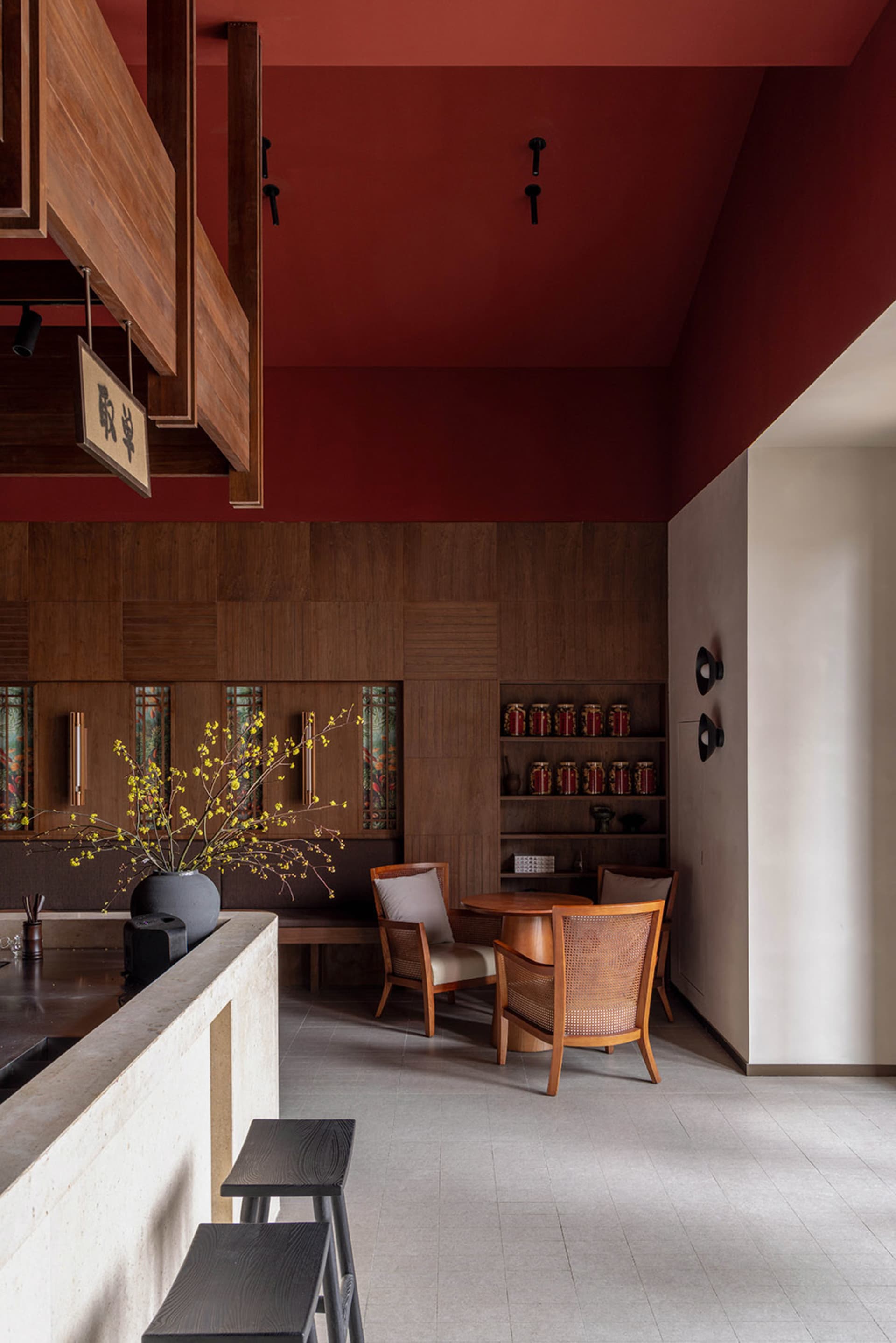 A modern restaurant interior with wooden walls and terrazzo flooring.