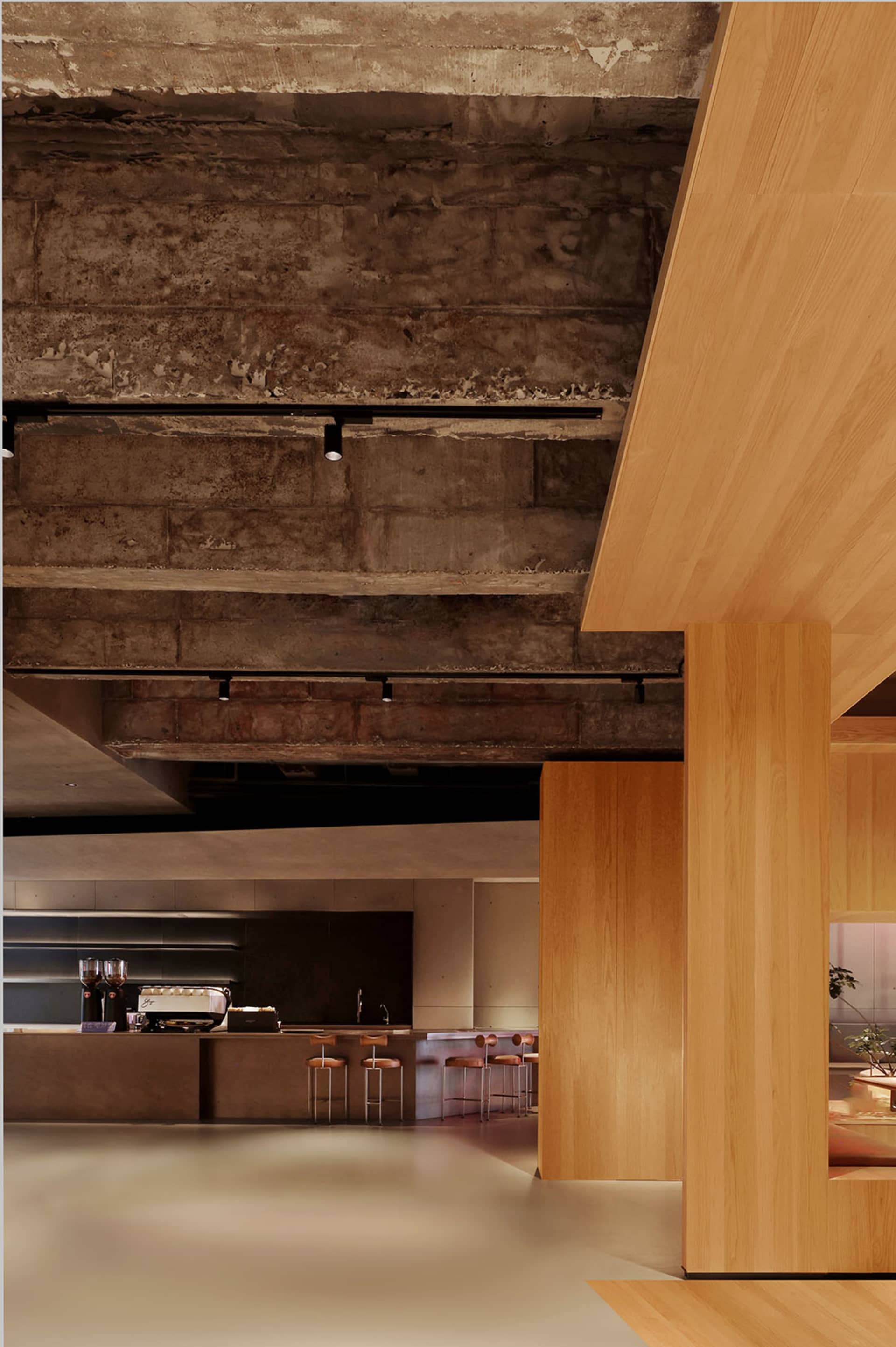 Photo of a modern restaurant interior with concrete walls and a minimalist design.