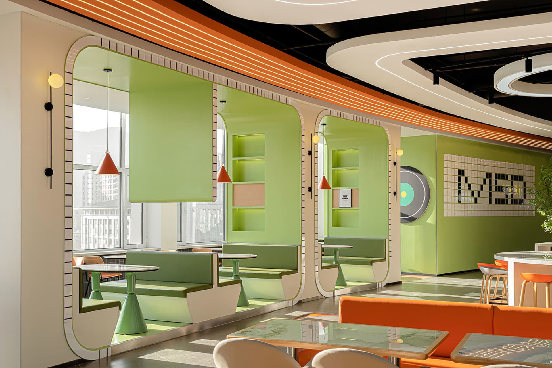 A modern cafe interior featuring green leather seating.