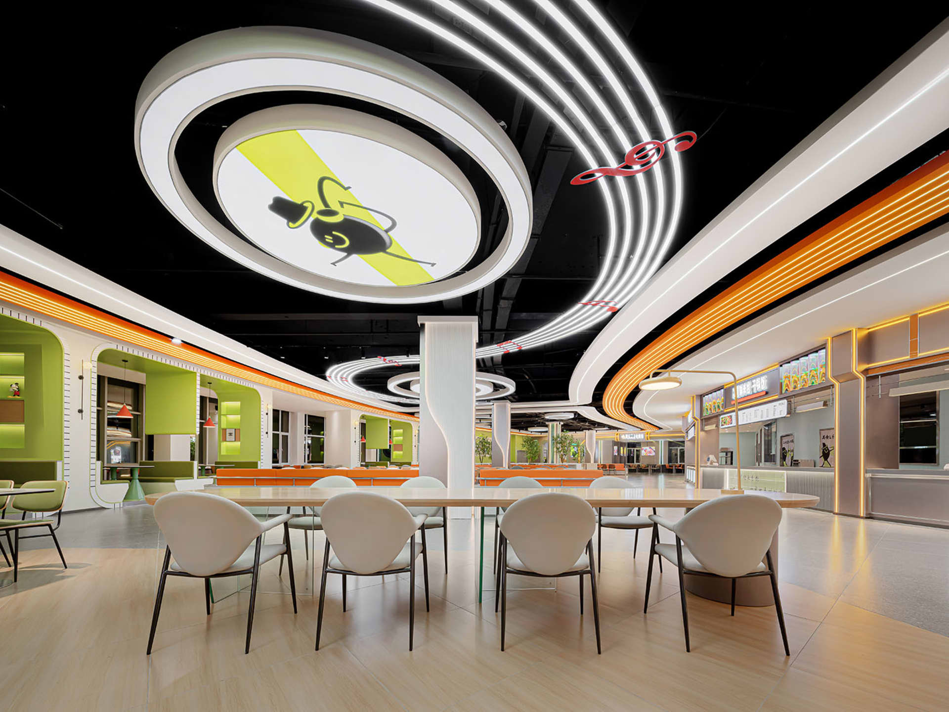 A spacious, modern eatery illuminated by neon lights.