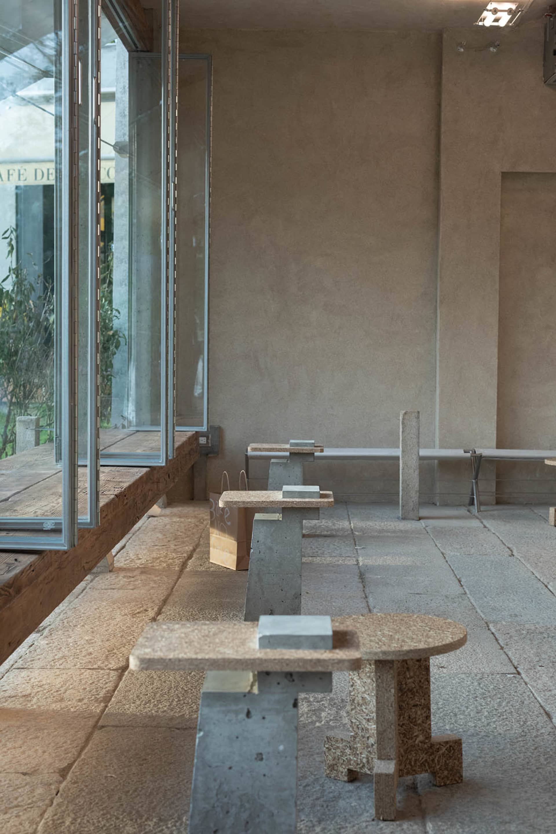 Minimalist modern interior space featuring concrete and terrazzo materials.