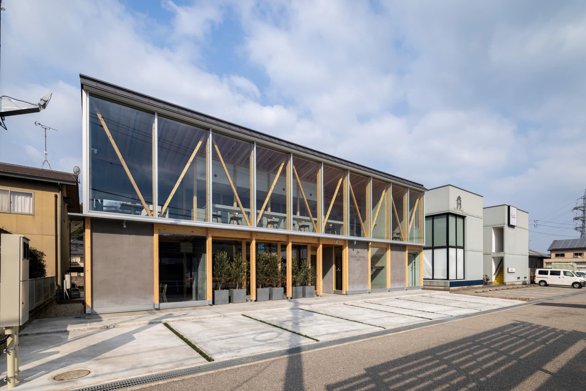 Modern coffee shop with large glass windows and concrete facade