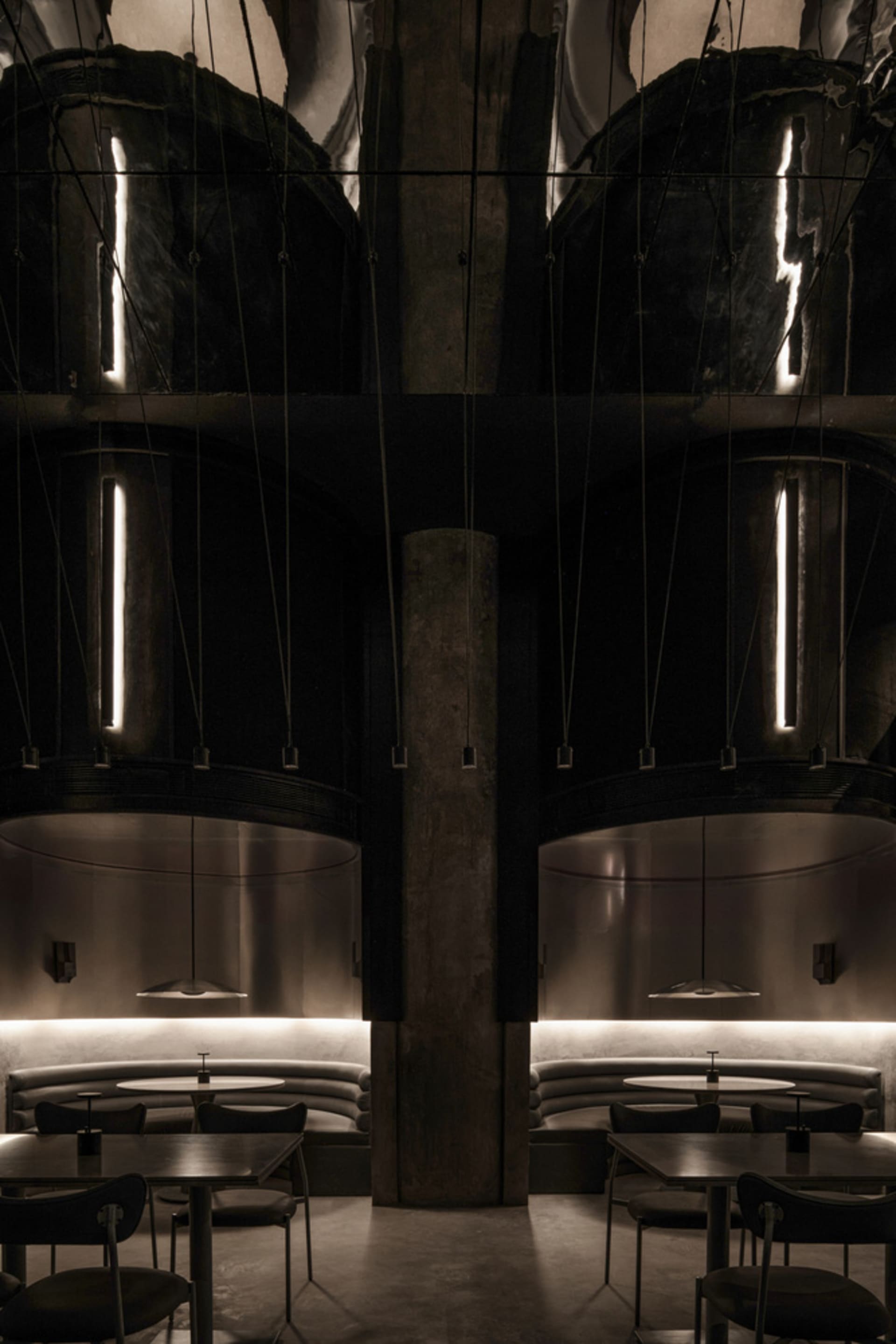 Industrial-style restaurant interior featuring metallic elements and modern seating.