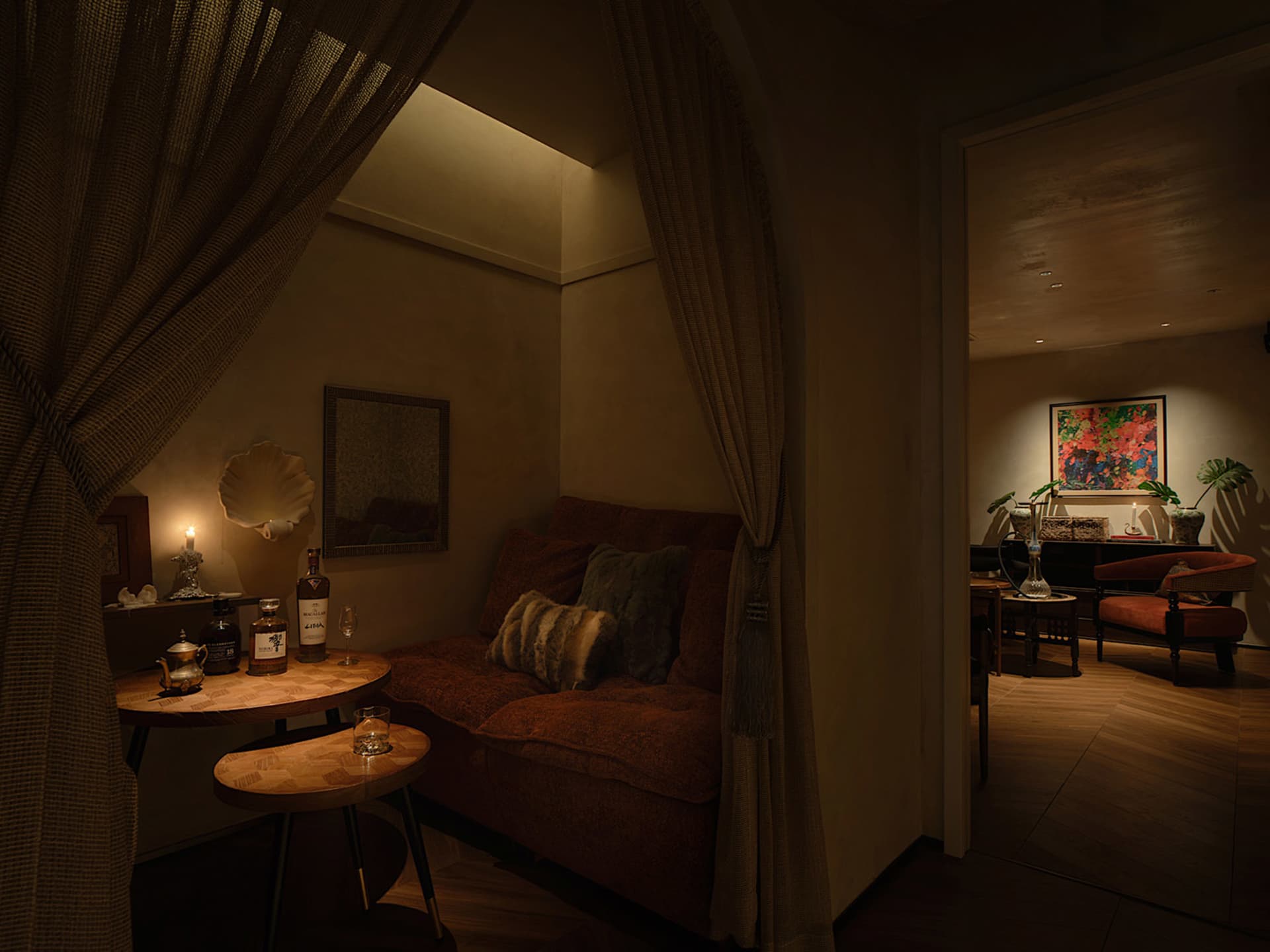 A cozy, industrial-style living space with a brown fabric sofa, decorative shell, and wooden side table.