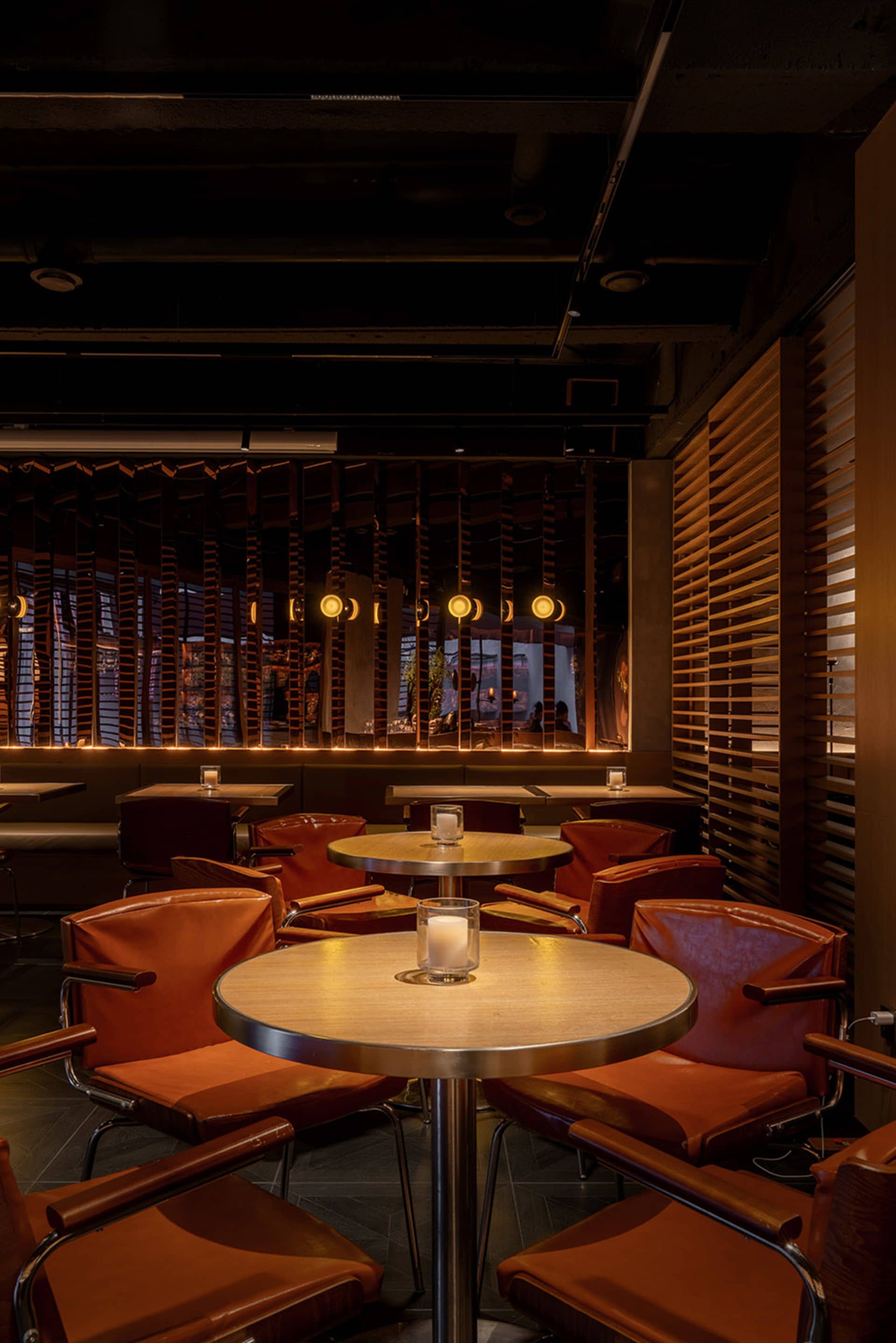 An industrial-style restaurant interior with wooden furniture and warm lighting.